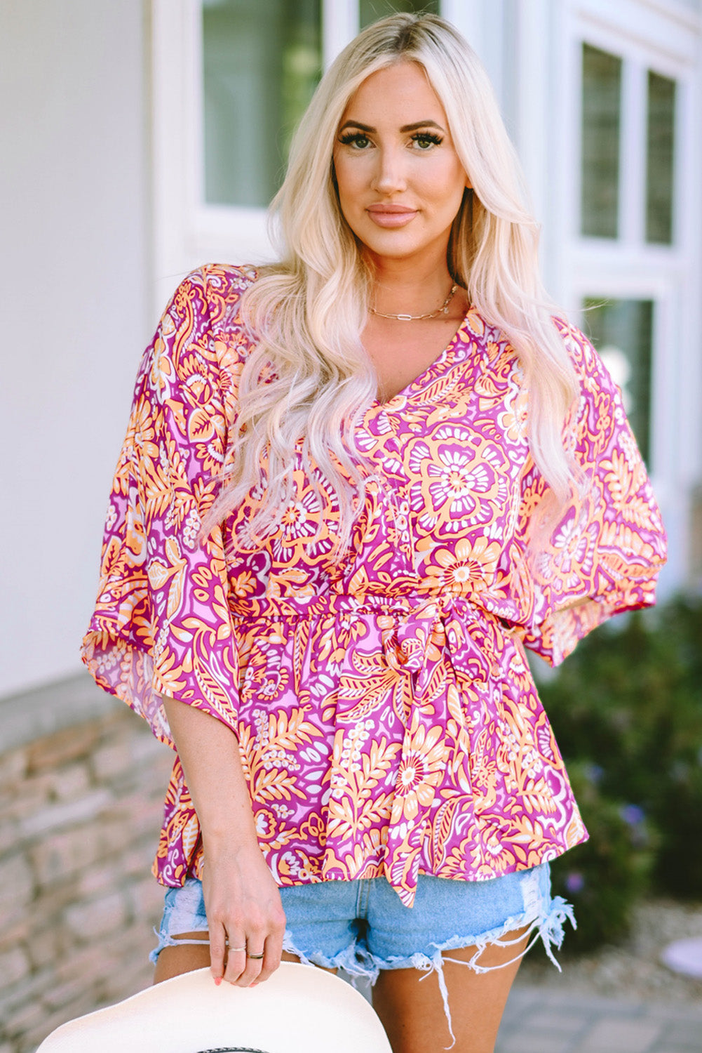 A stylish Boho Floral Belted Blouse featuring vibrant floral patterns, a waist tie, and wide short sleeves, perfect for a chic look.