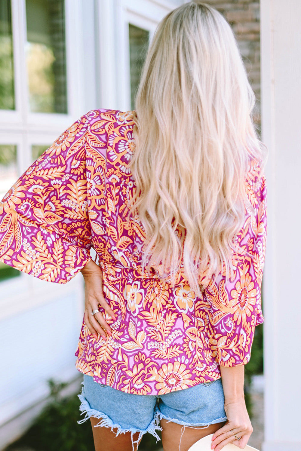 A stylish Boho Floral Belted Blouse featuring vibrant floral patterns, a waist tie, and wide short sleeves, perfect for a chic look.