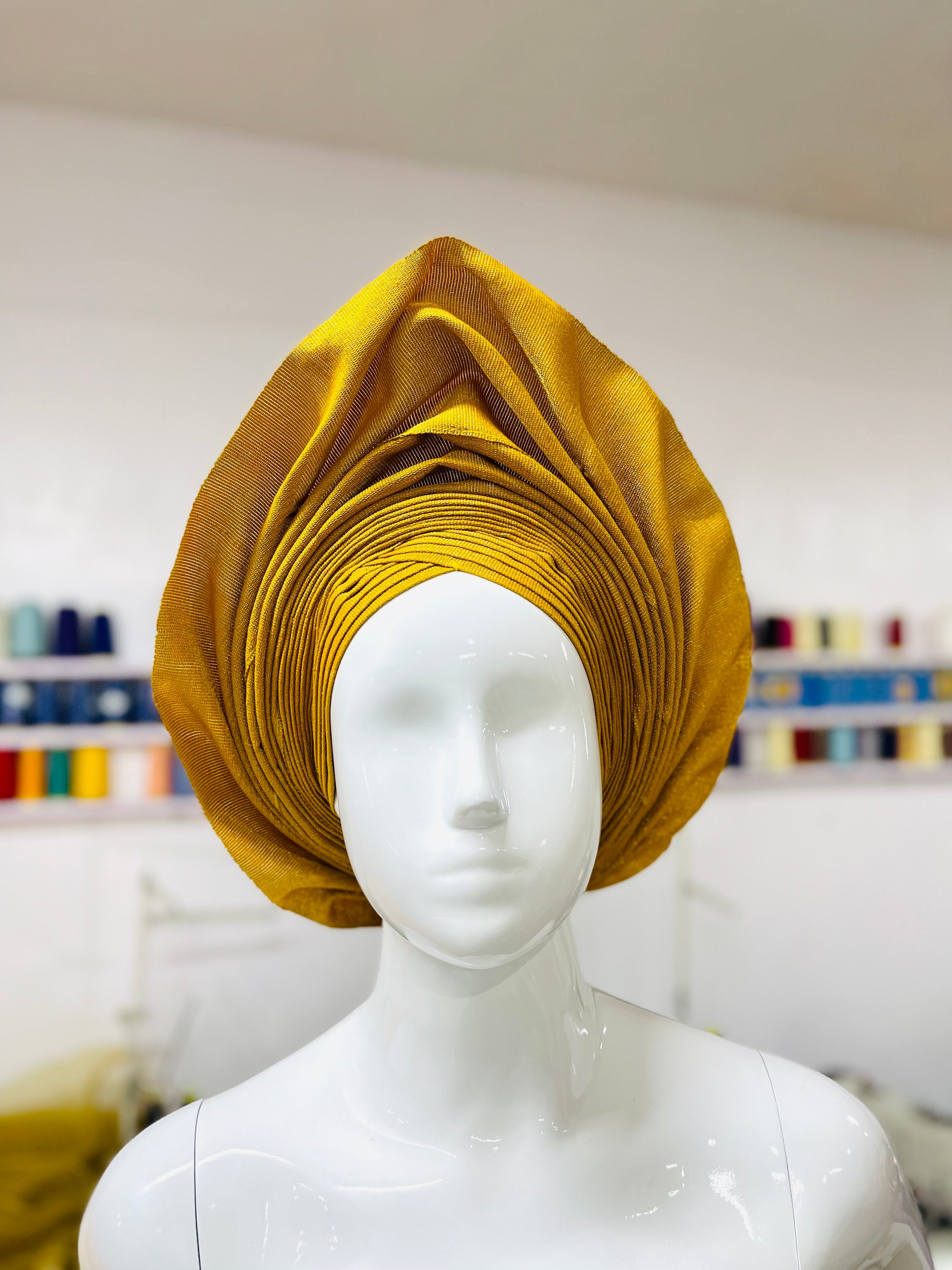 Bola Gele Headgear displayed elegantly in a personalized gift box, showcasing its vibrant colors and stylish design.