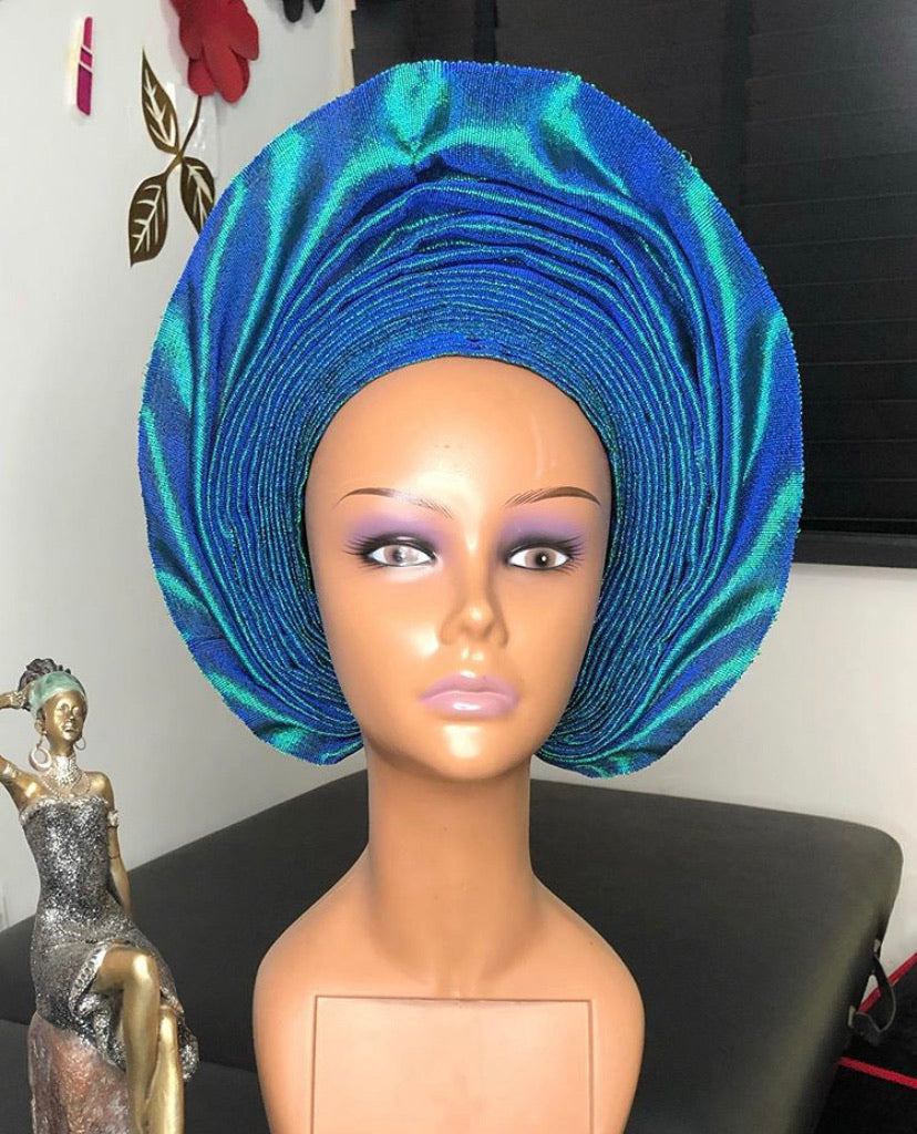 Bola Gele Headgear displayed elegantly in a personalized gift box, showcasing its vibrant colors and stylish design.