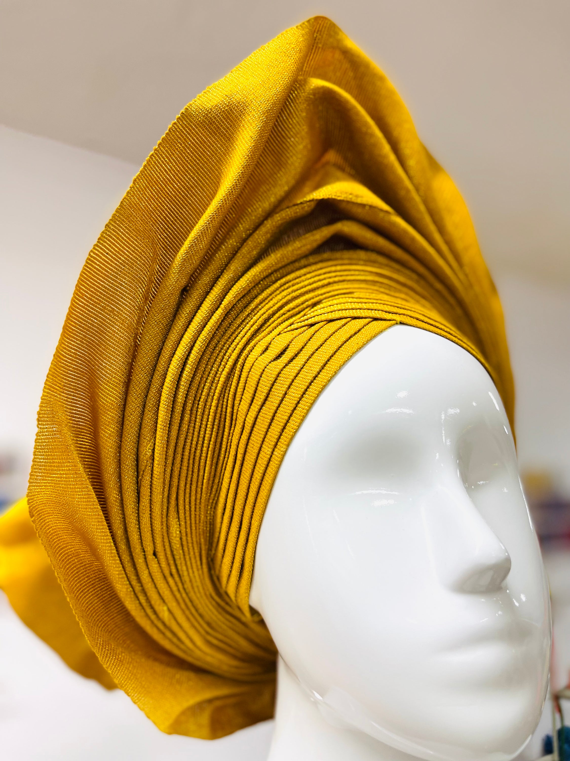 Bola Gele Headgear displayed elegantly in a personalized gift box, showcasing its vibrant colors and stylish design.