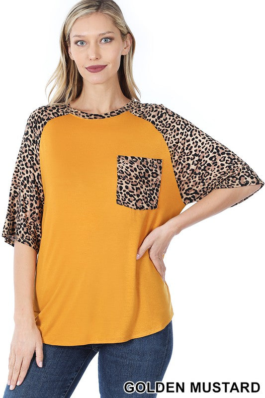 A stylish Bold Leopard Print Blouse featuring a relaxed fit, elbow-length sleeves, and a large chest pocket, with vibrant colors and leopard print details.