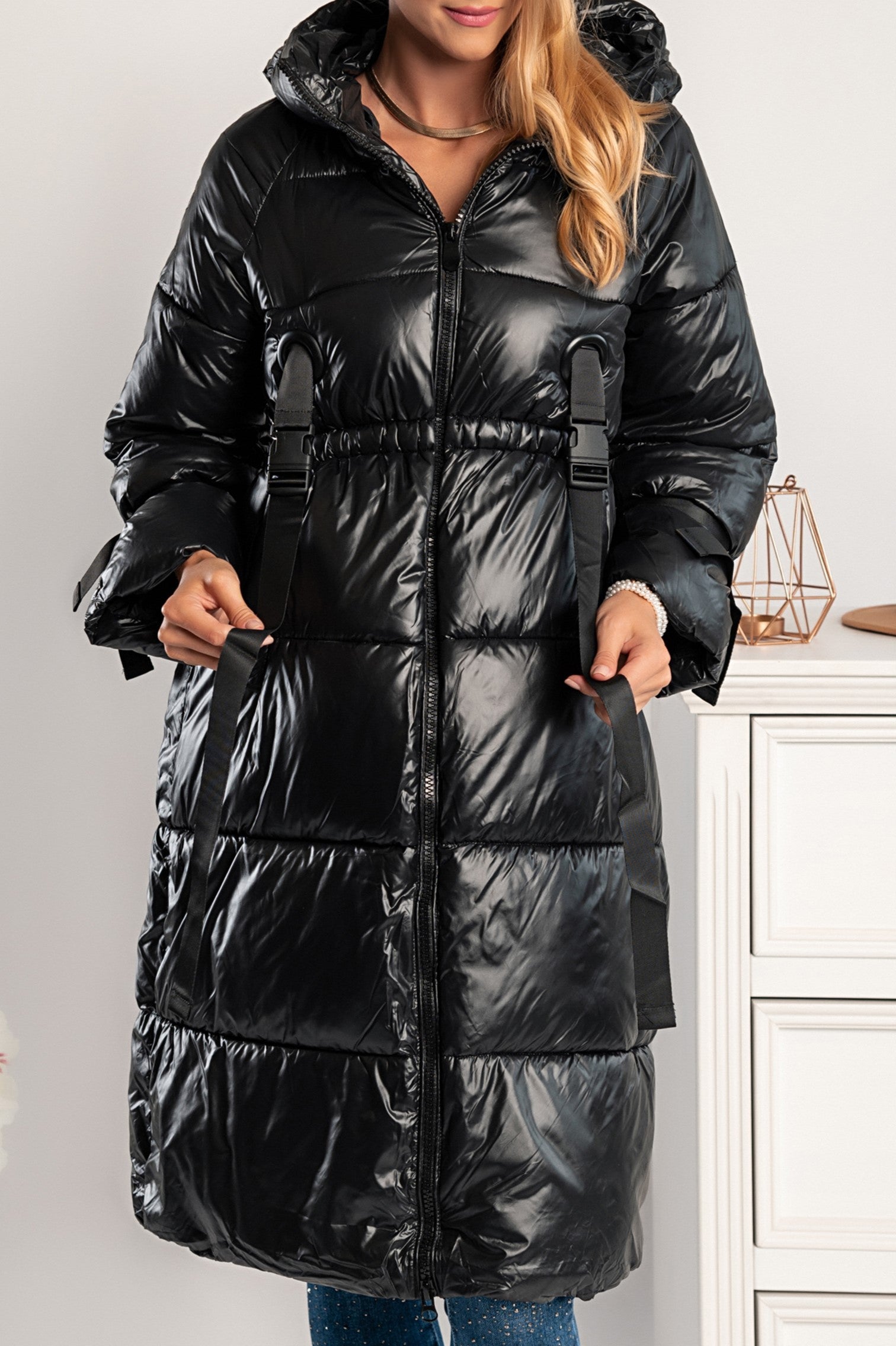 Bonea long quilted jacket in black with a hood, featuring two front pockets and a stylish black buckle.