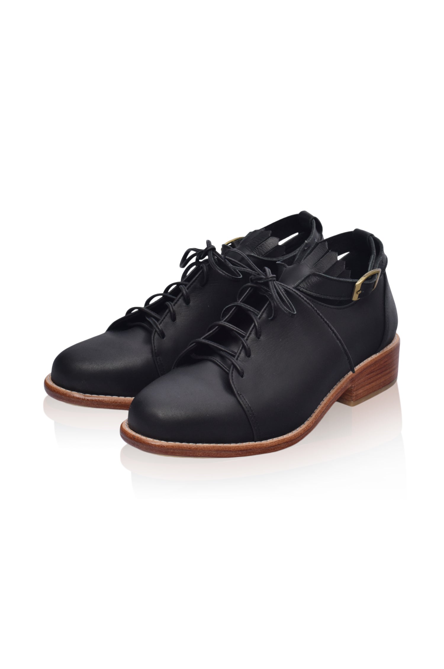 A pair of stylish Boston Leather Oxfords featuring fringe detailing and an ankle strap, made from genuine leather.