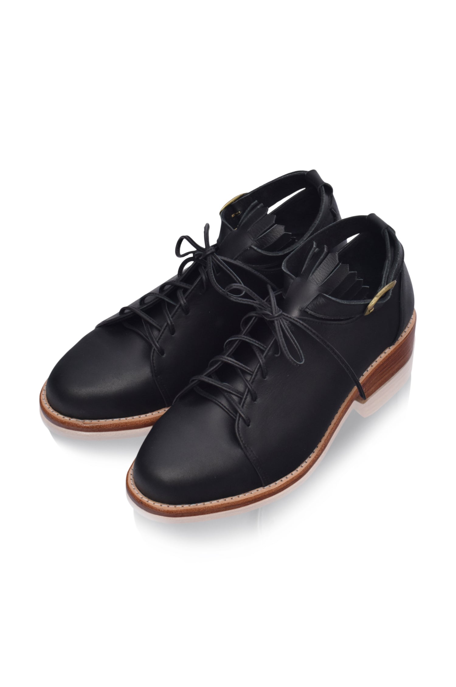 A pair of stylish Boston Leather Oxfords featuring fringe detailing and an ankle strap, made from genuine leather.