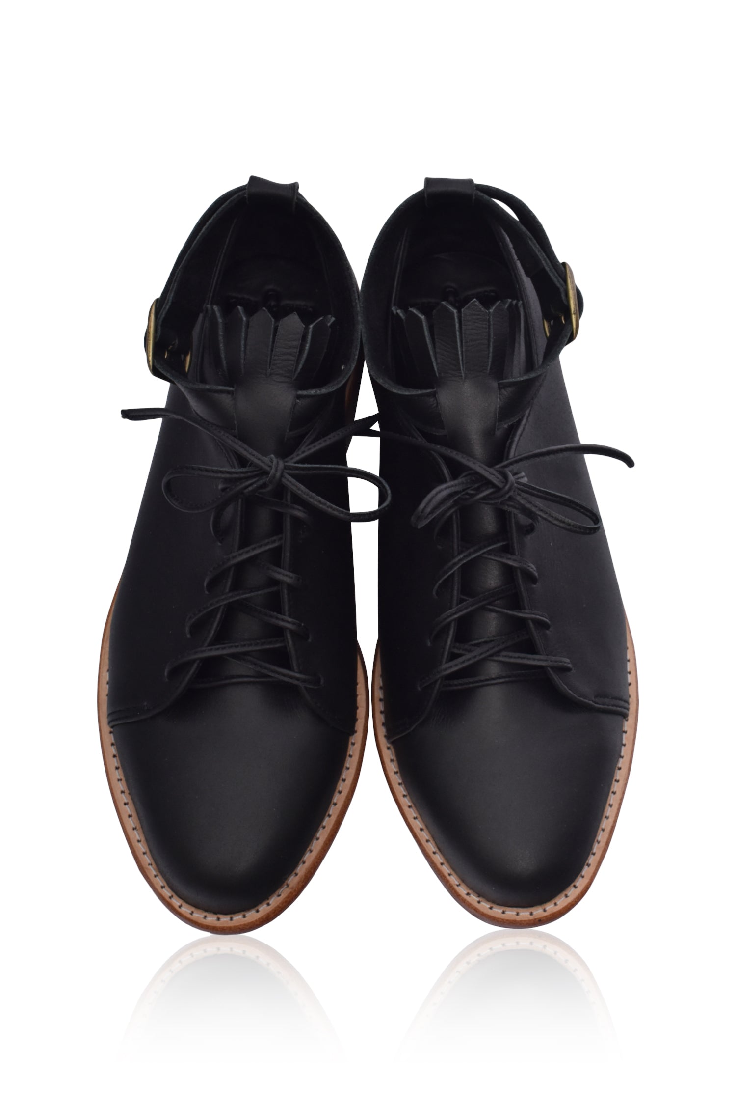 A pair of stylish Boston Leather Oxfords featuring fringe detailing and an ankle strap, made from genuine leather.