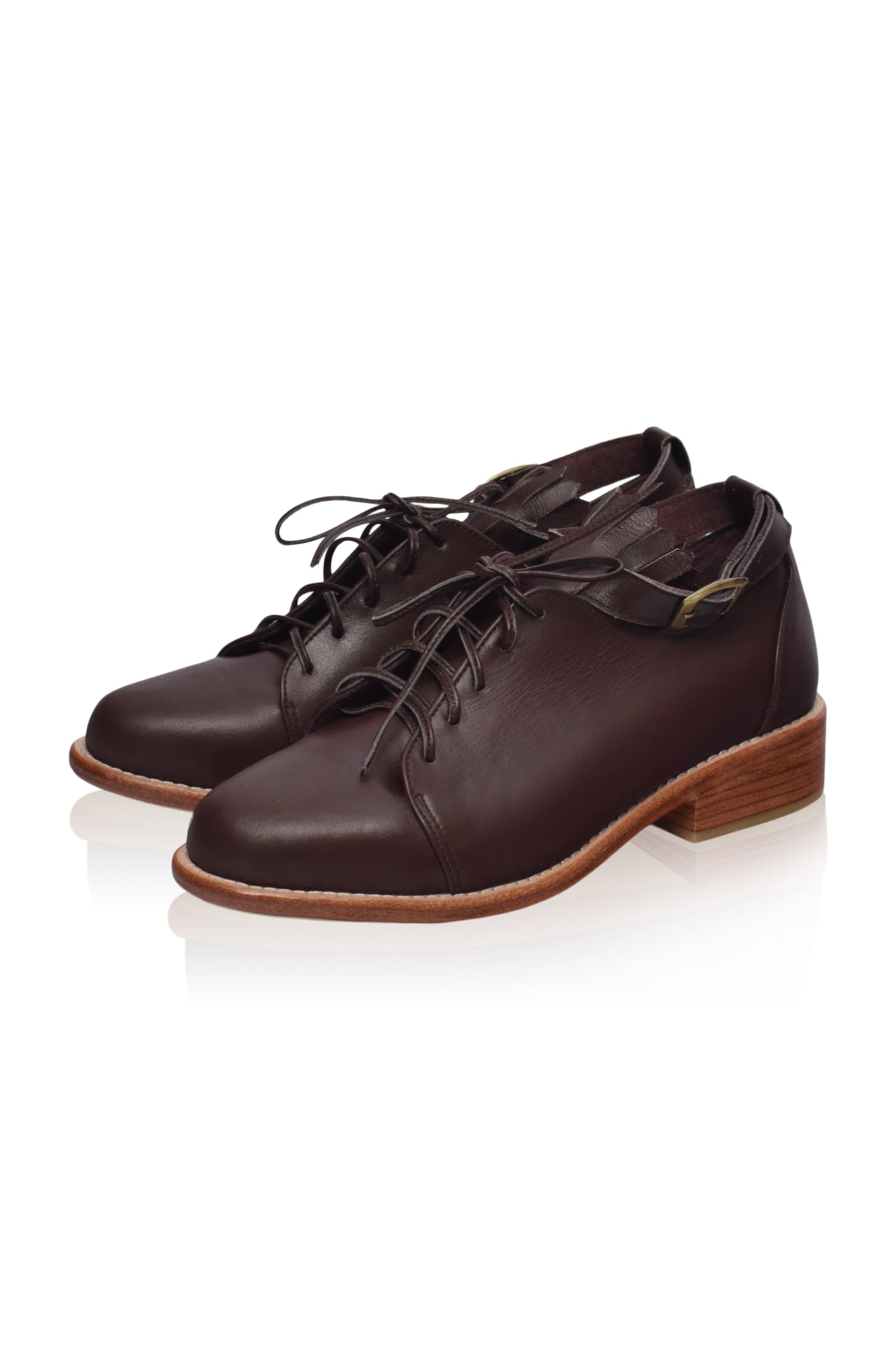 A pair of stylish Boston Leather Oxfords featuring fringe detailing and an ankle strap, made from genuine leather.