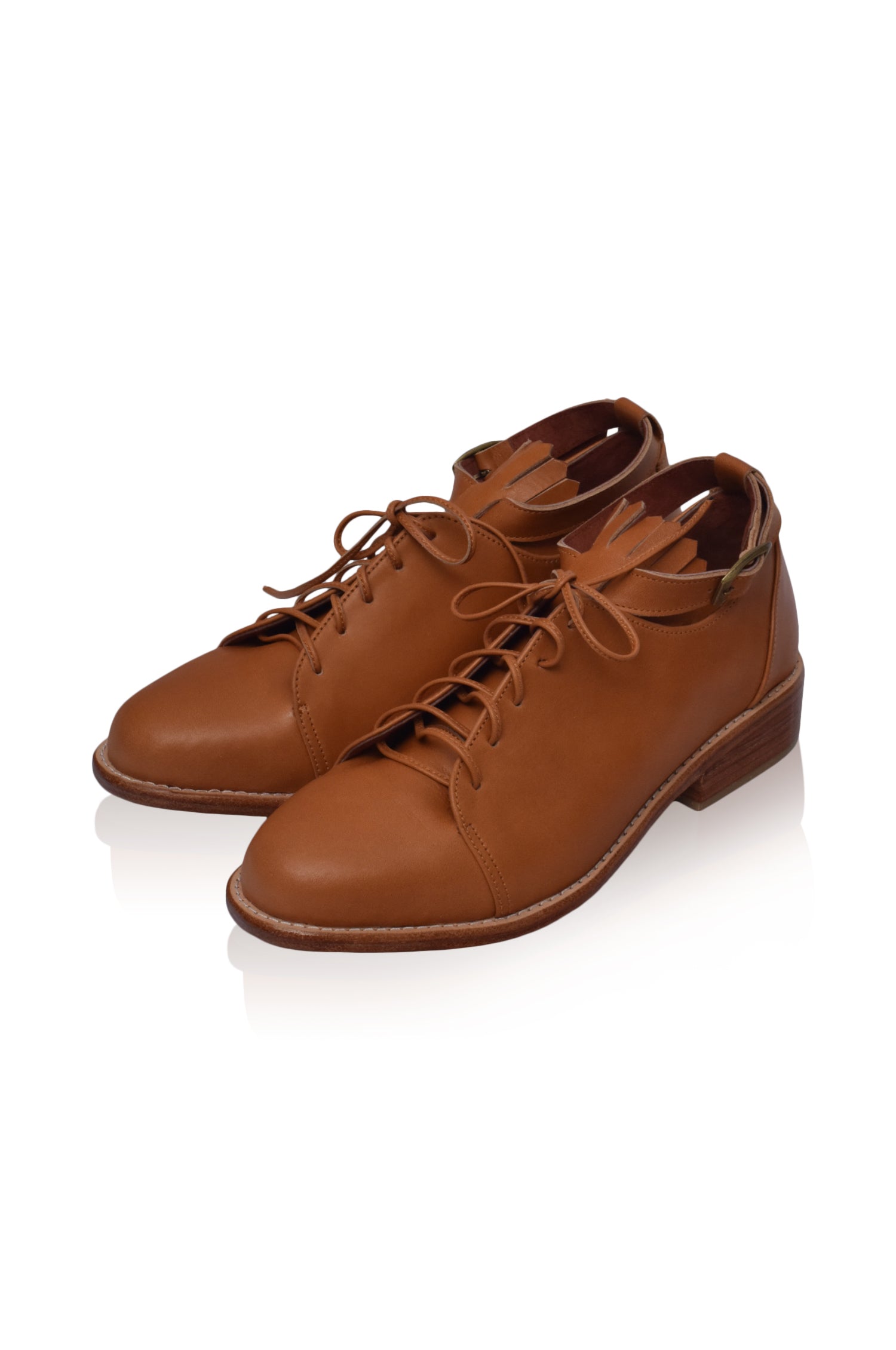 A pair of stylish Boston Leather Oxfords featuring fringe detailing and an ankle strap, made from genuine leather.