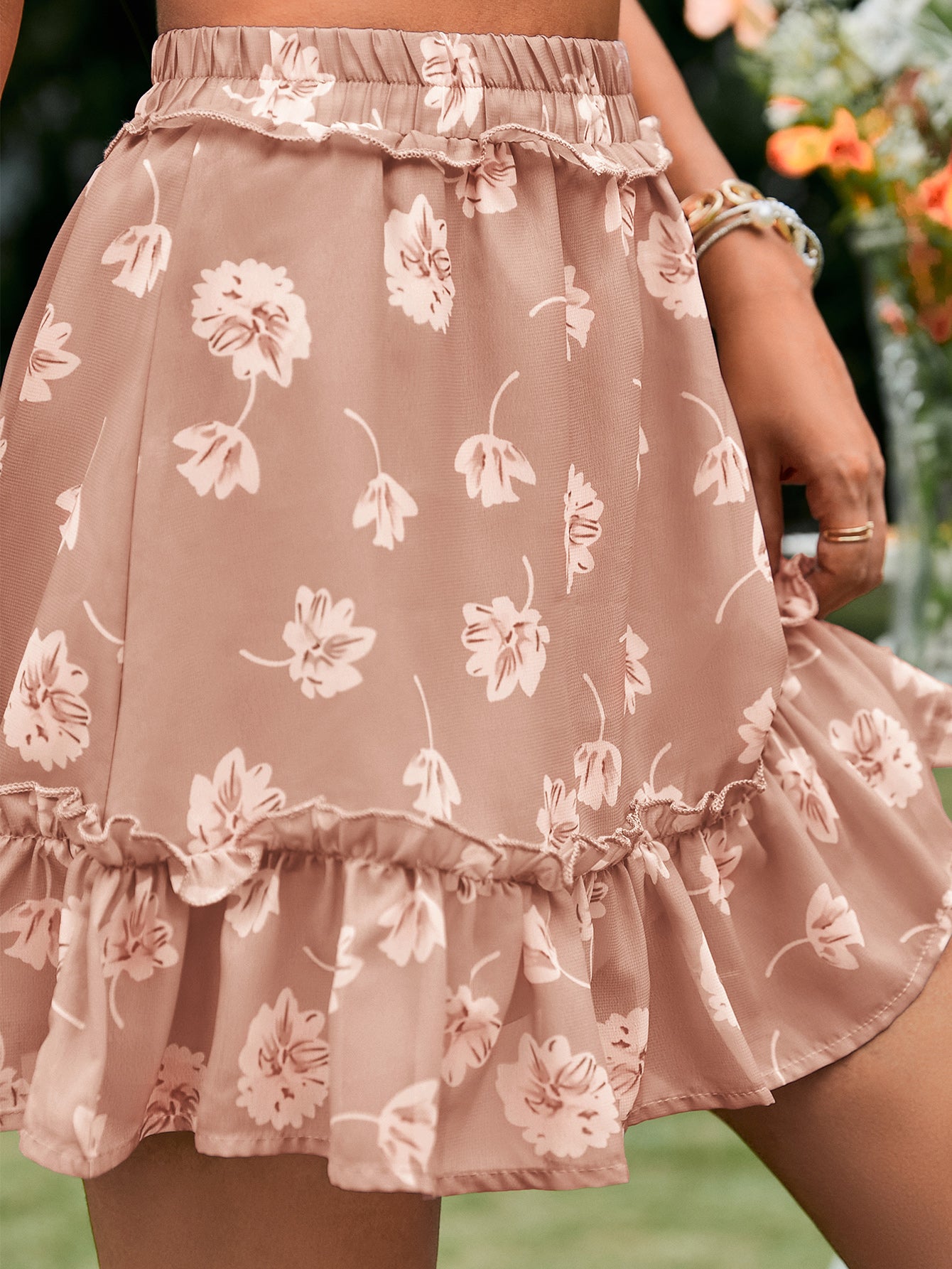 A stylish botanical print frill trim tiered skirt with an elastic waist, showcasing a vibrant floral pattern.