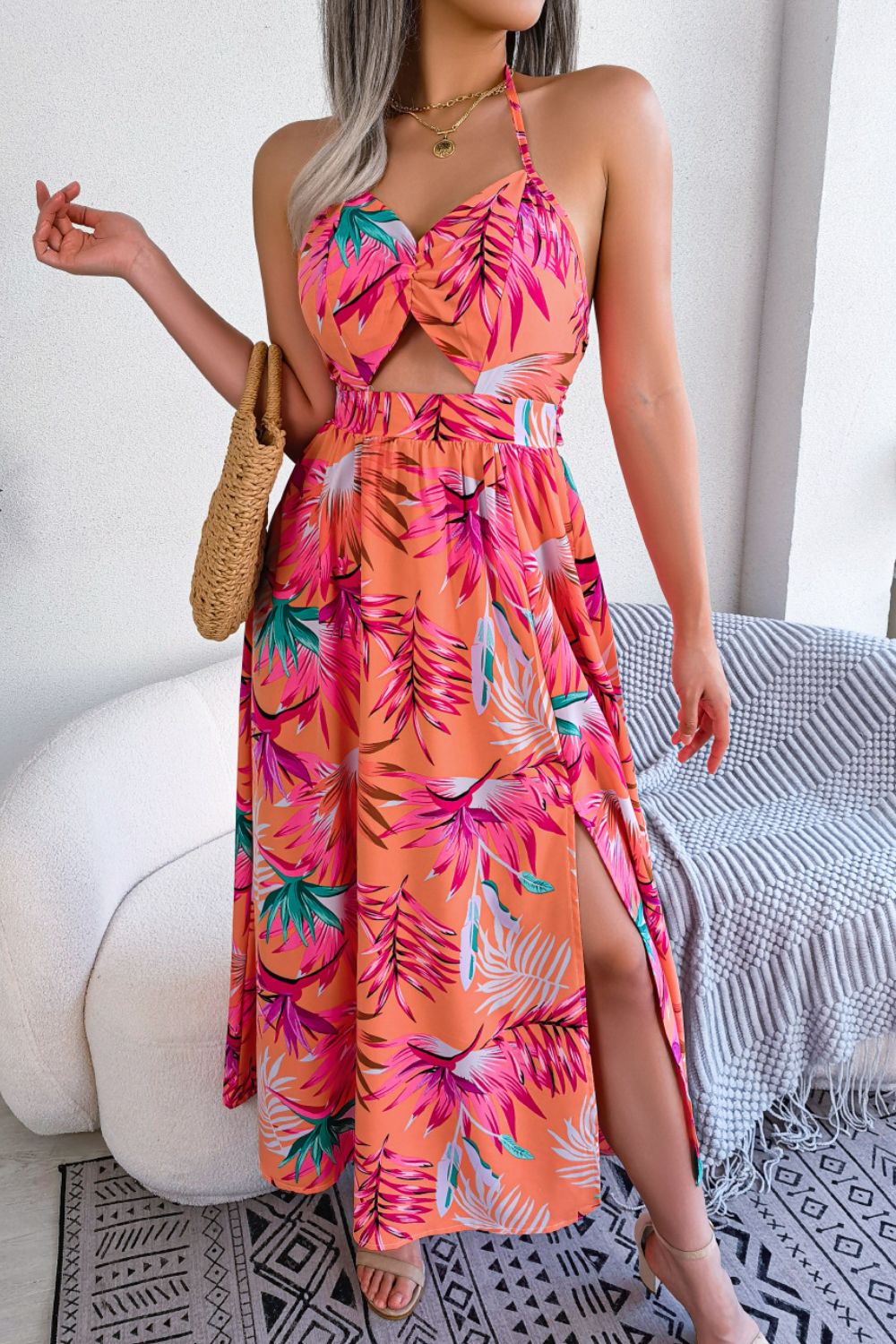 A stylish botanical print tied backless cutout slit dress, featuring a halter neck and flowing maxi length, perfect for casual and semi-formal occasions.