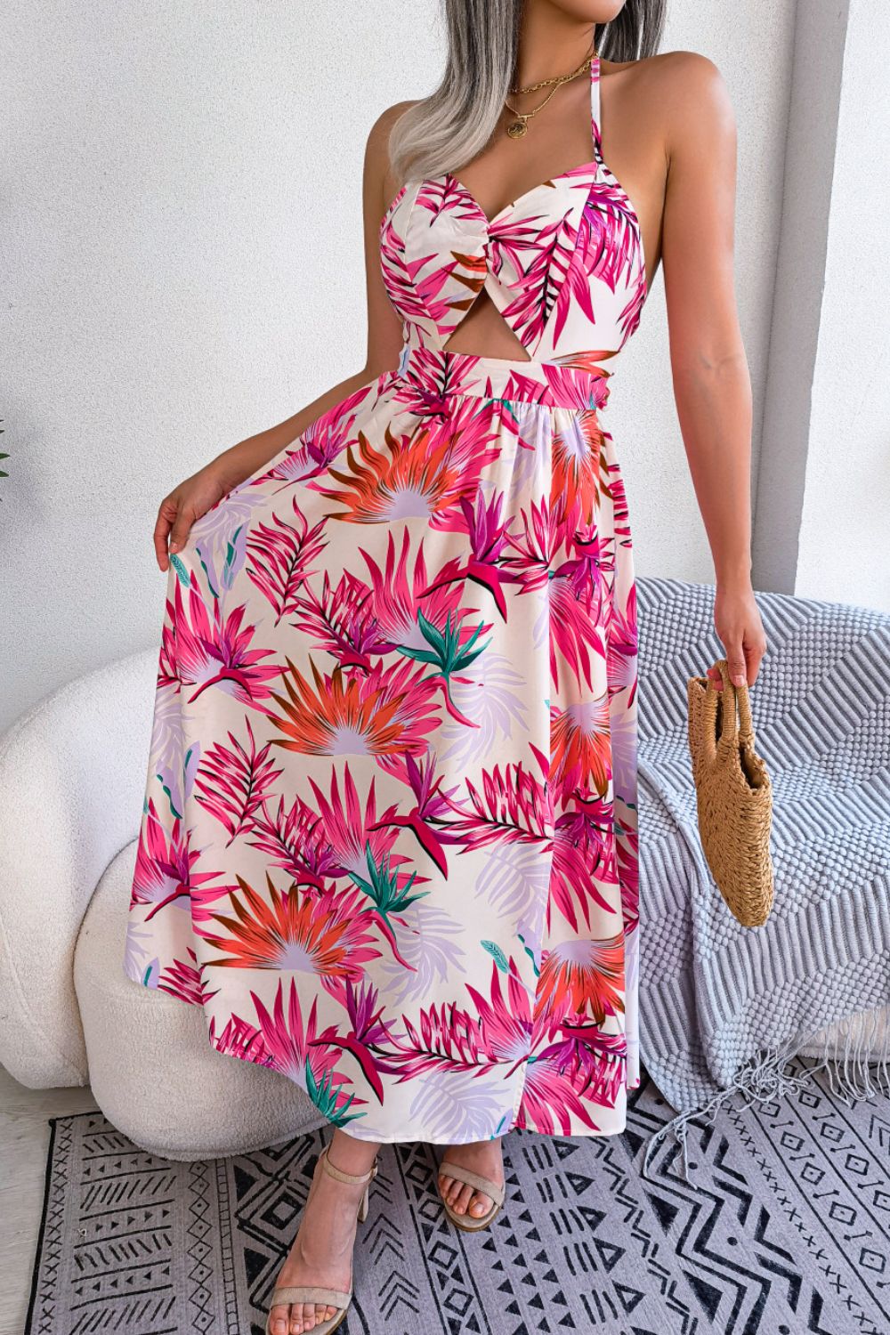 A stylish botanical print tied backless cutout slit dress, featuring a halter neck and flowing maxi length, perfect for casual and semi-formal occasions.