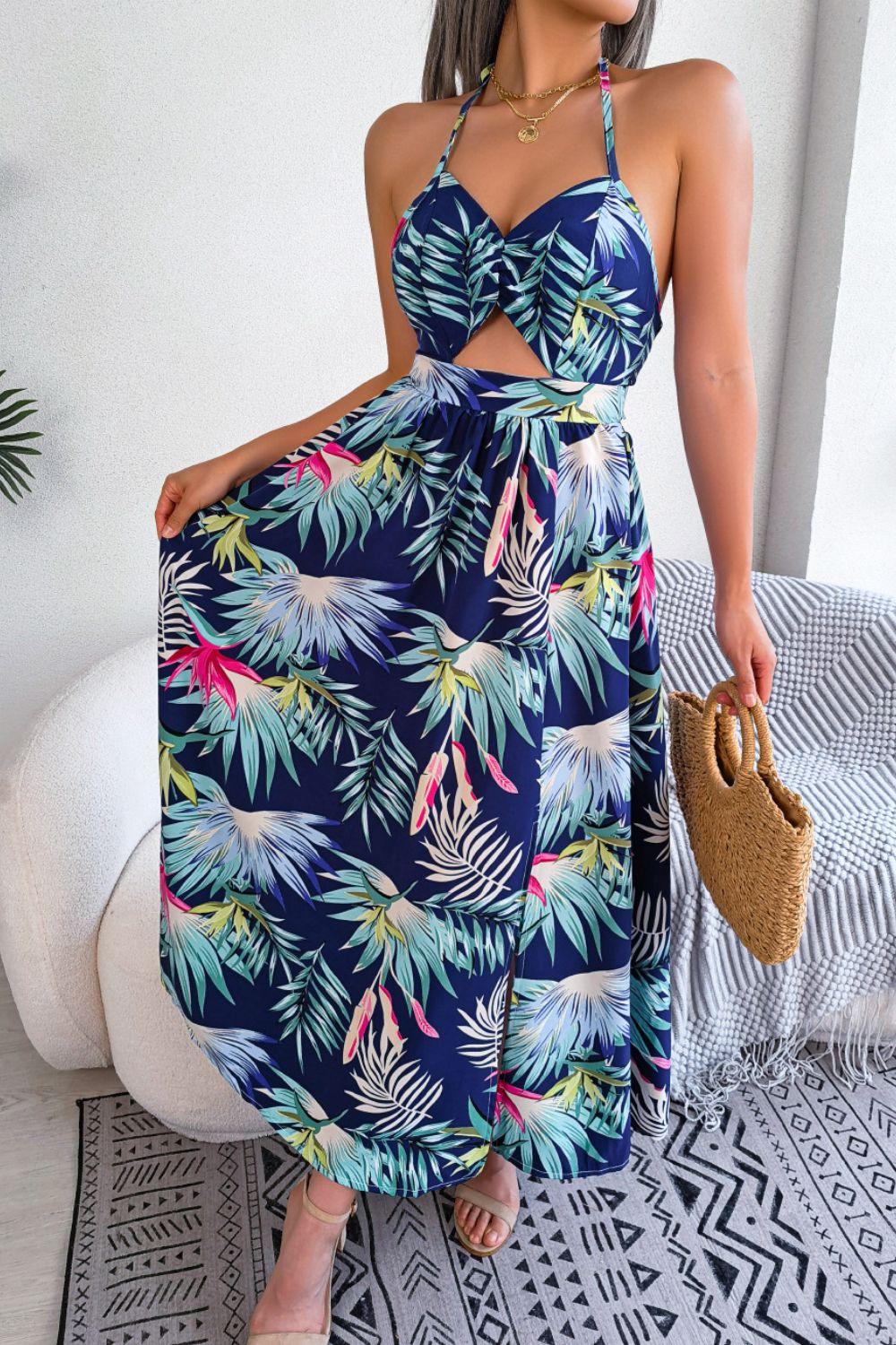 A stylish botanical print tied backless cutout slit dress, featuring a halter neck and flowing maxi length, perfect for casual and semi-formal occasions.