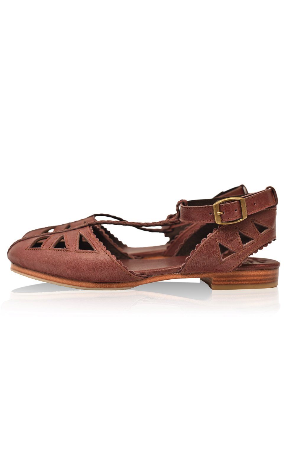 Bounty T-strap Leather Sandals showcasing a stylish design with round toe and scalloped edges, made from genuine leather.