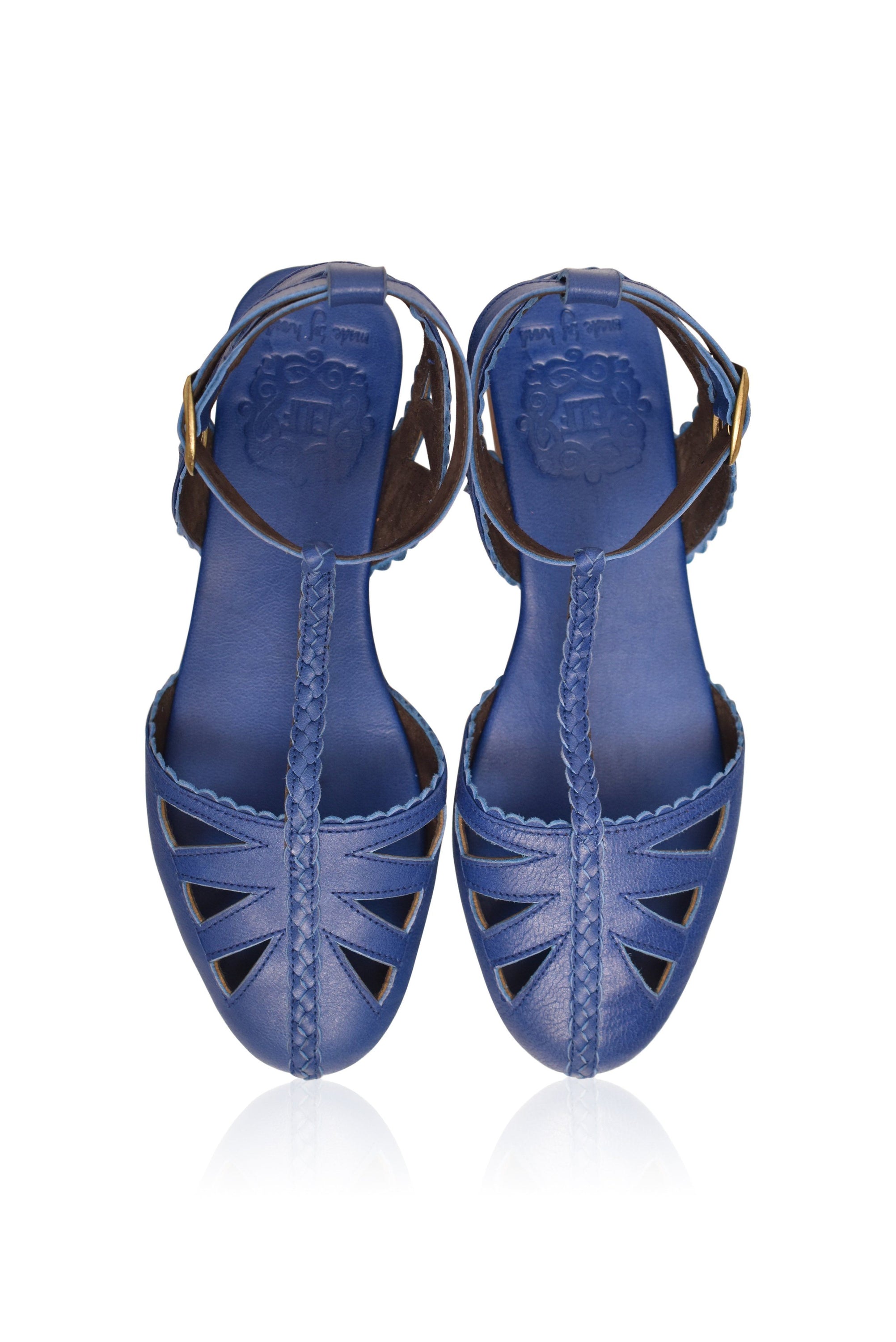 Bounty T-strap Leather Sandals showcasing round toe, cutouts, and scalloped edges in a stylish design.