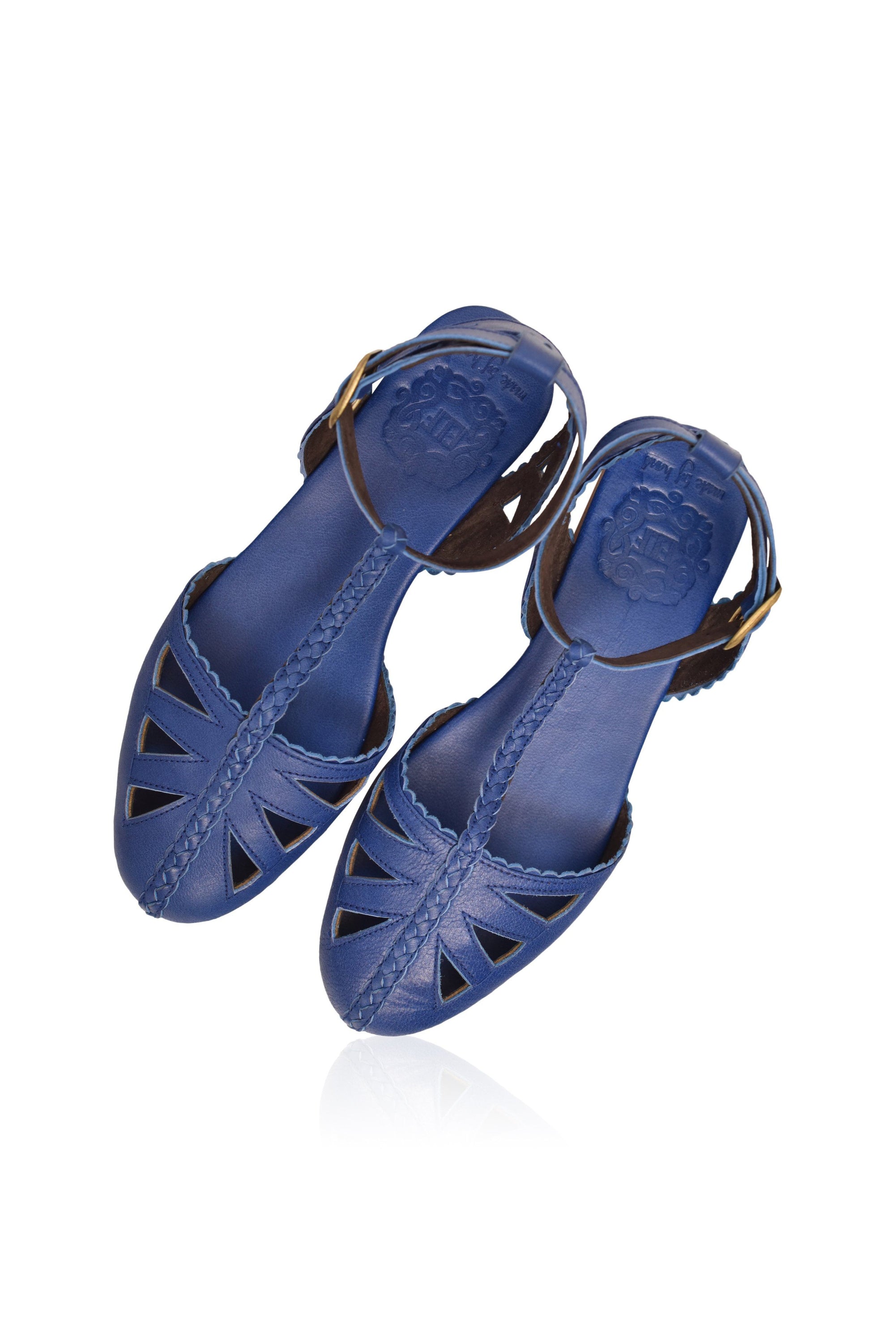 Bounty T-strap Leather Sandals showcasing round toe, cutouts, and scalloped edges in a stylish design.