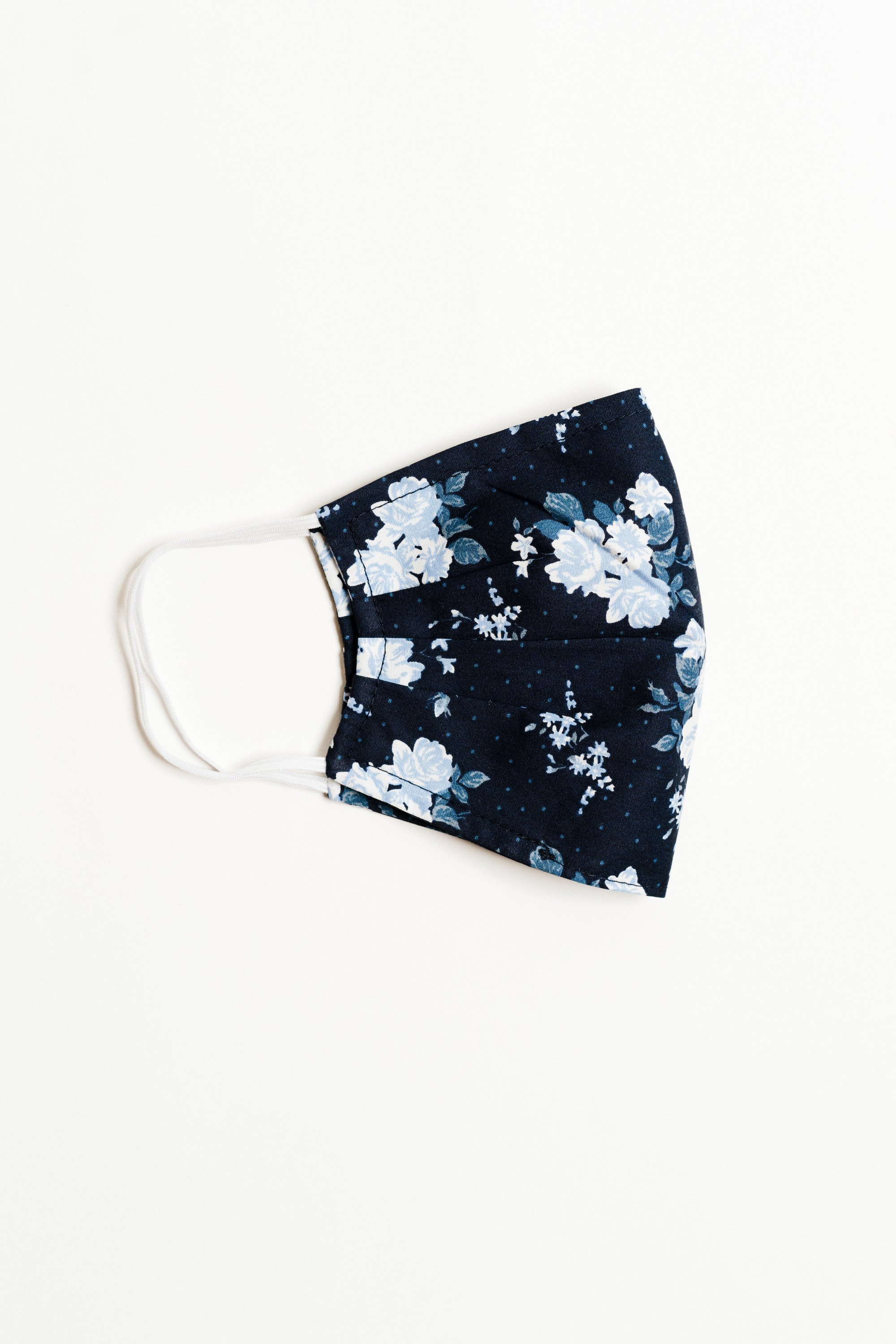 Bouquet Navy Face Mask made of breathable cotton with pleats for comfort and a filter pocket.