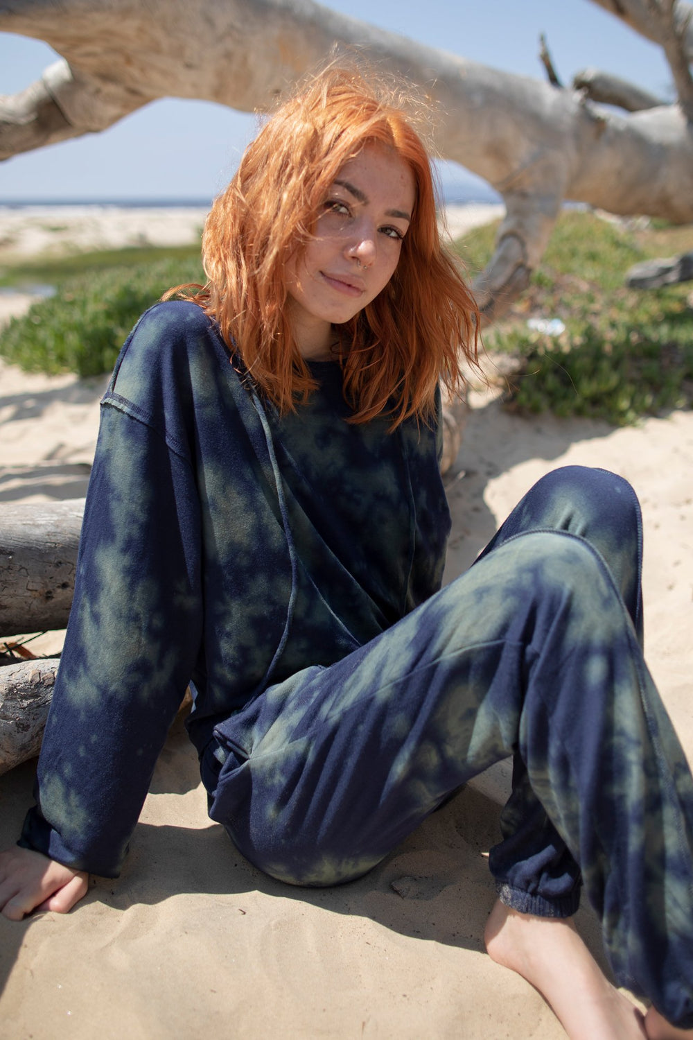 A stylish blue tie-dye boxy hoodie with raw hems and flared sleeves, perfect for casual wear.