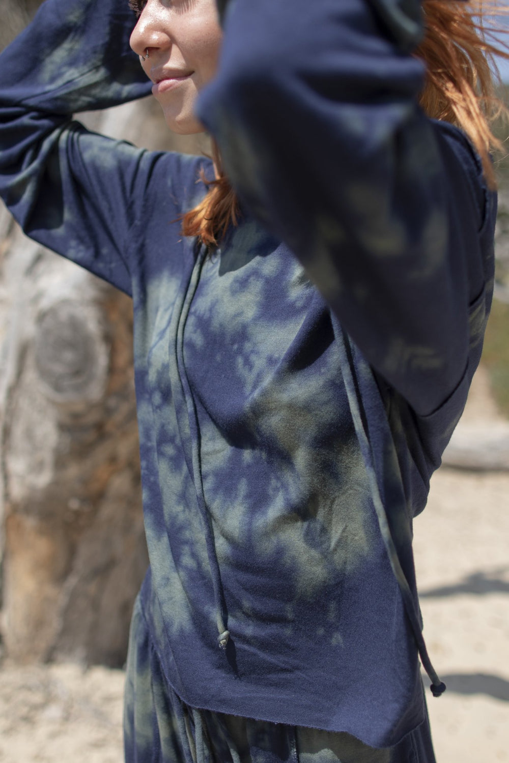 A stylish blue tie-dye boxy hoodie with raw hems and flared sleeves, perfect for casual wear.