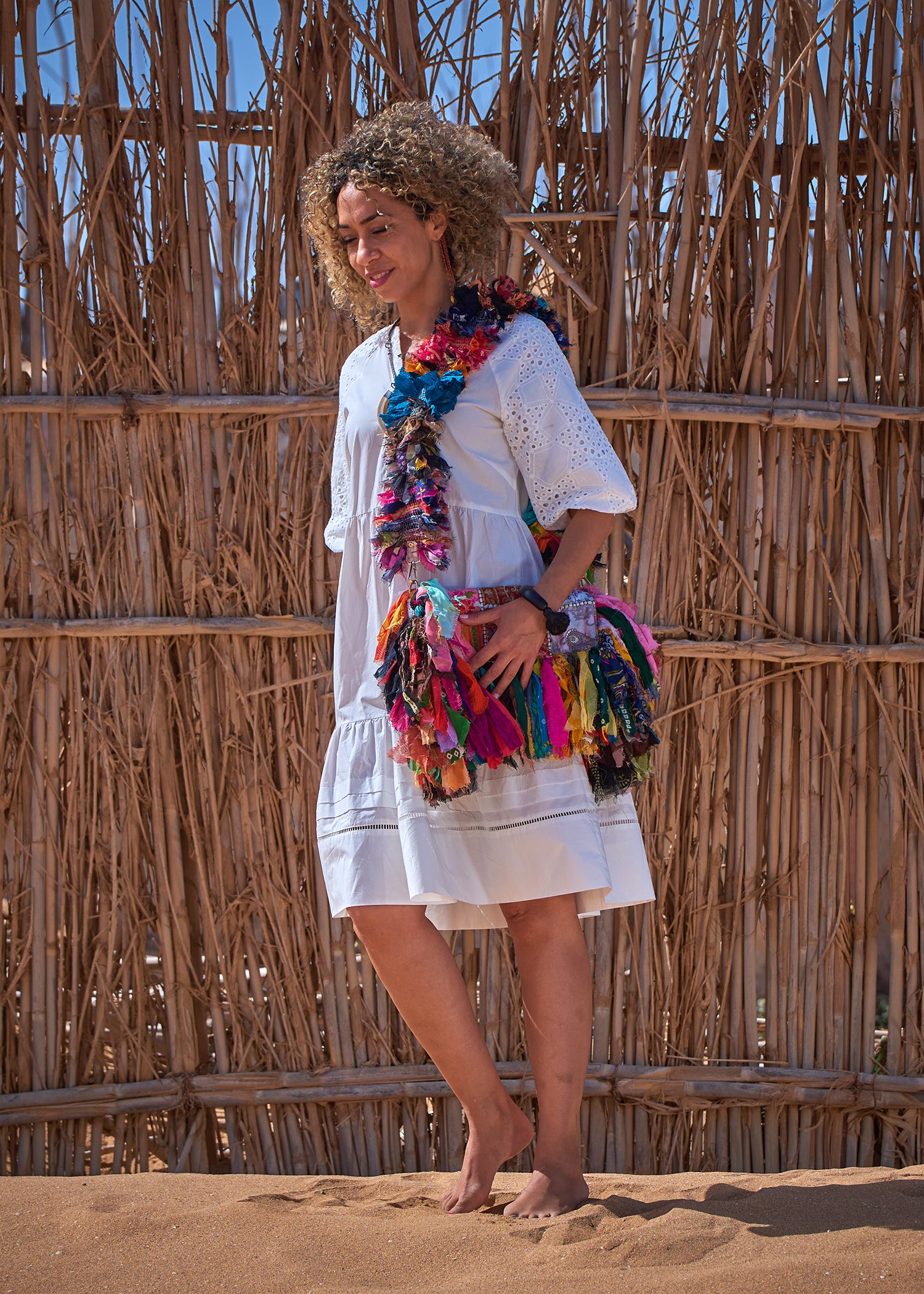 A relaxed white tiered dress featuring broderie anglaise puff sleeves and a notch neck with ladder lace trim, perfect for any occasion.