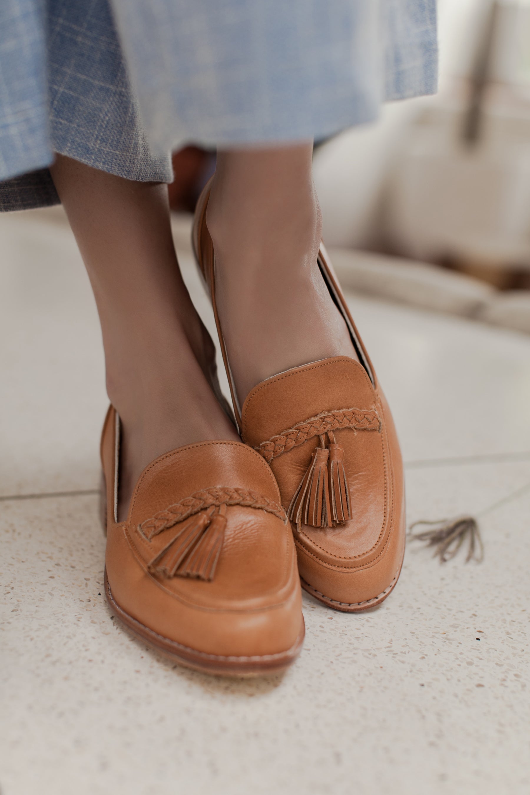 A pair of stylish Brooklyn leather loafers featuring braid and tassel details, made from 100% genuine leather.