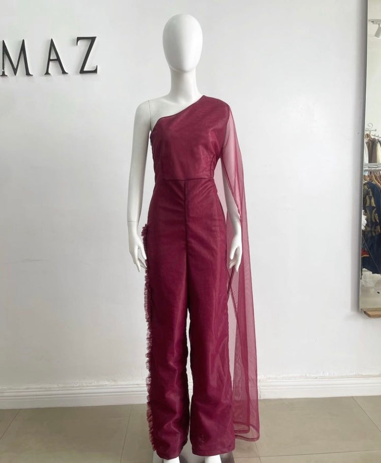 A stylish burgundy jumpsuit featuring a one-shoulder design and elegant tulle fabric, perfect for formal occasions.