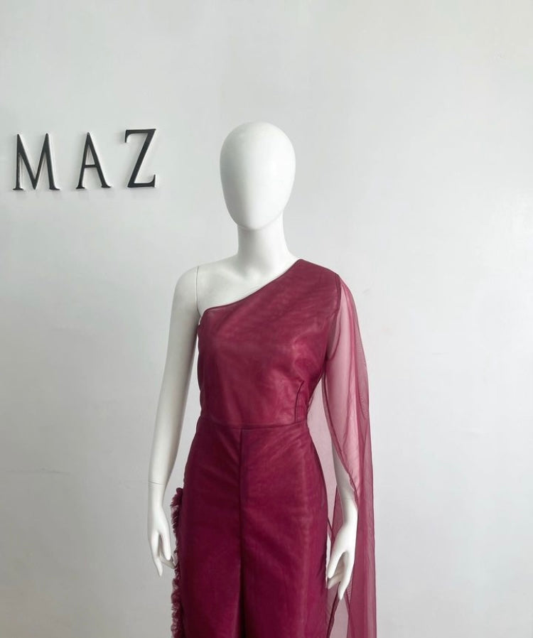 A stylish burgundy jumpsuit featuring a one-shoulder design and elegant tulle fabric, perfect for formal occasions.