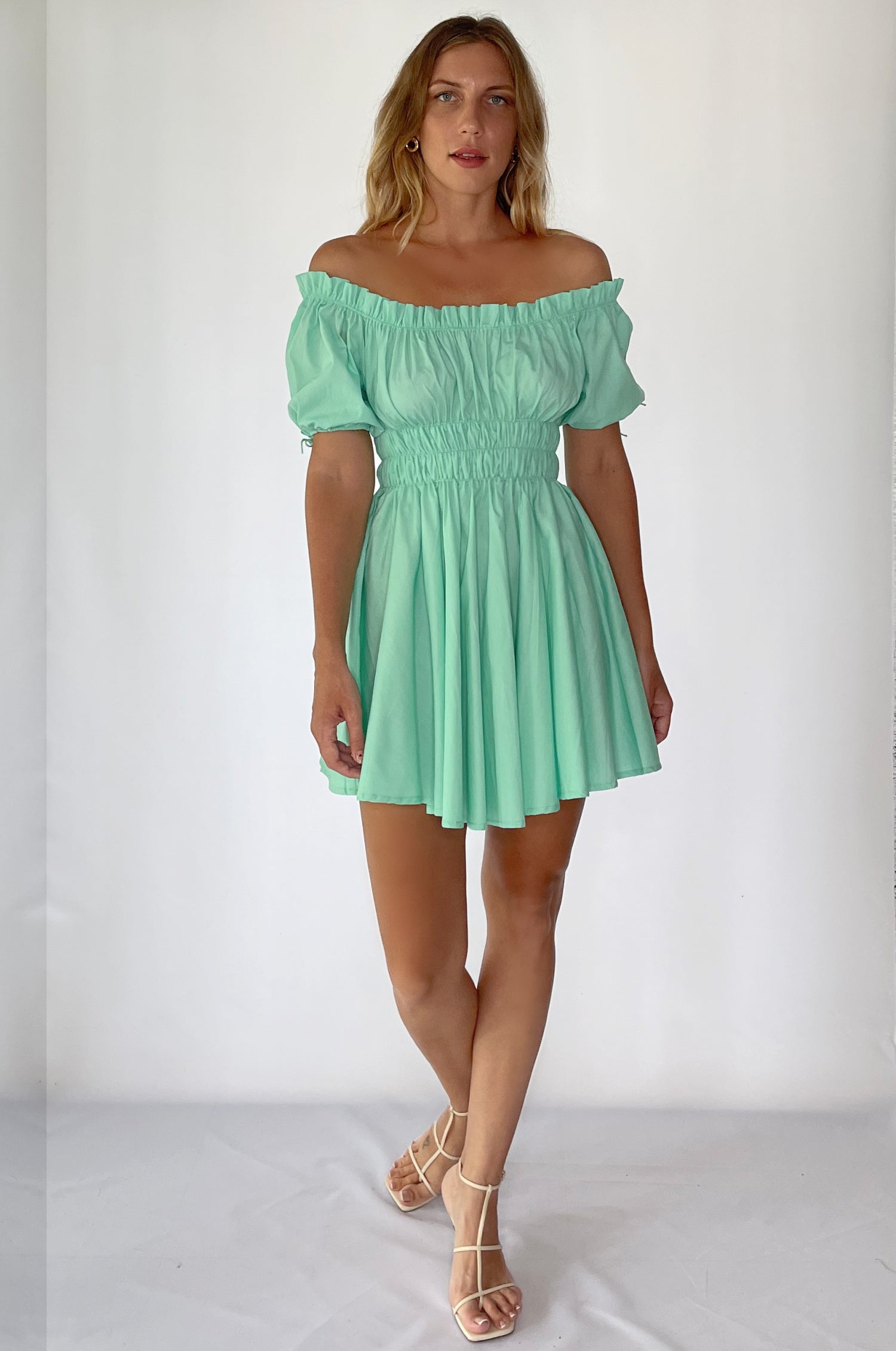 Butterfly Bliss Off Shoulder Mini Dress featuring puffed sleeves and a ruffled neckline, made from airy organic cotton in various colors.