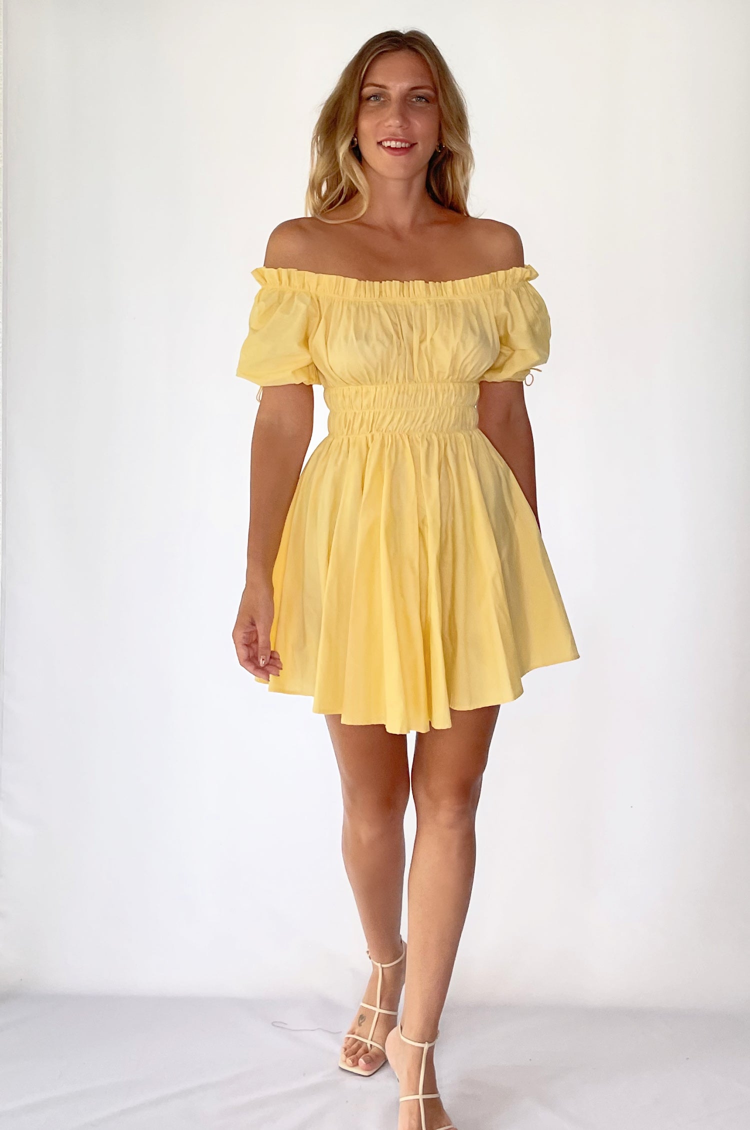 Butterfly Bliss Off Shoulder Mini Dress featuring puffed sleeves and a ruffled neckline, made from airy organic cotton in various colors.