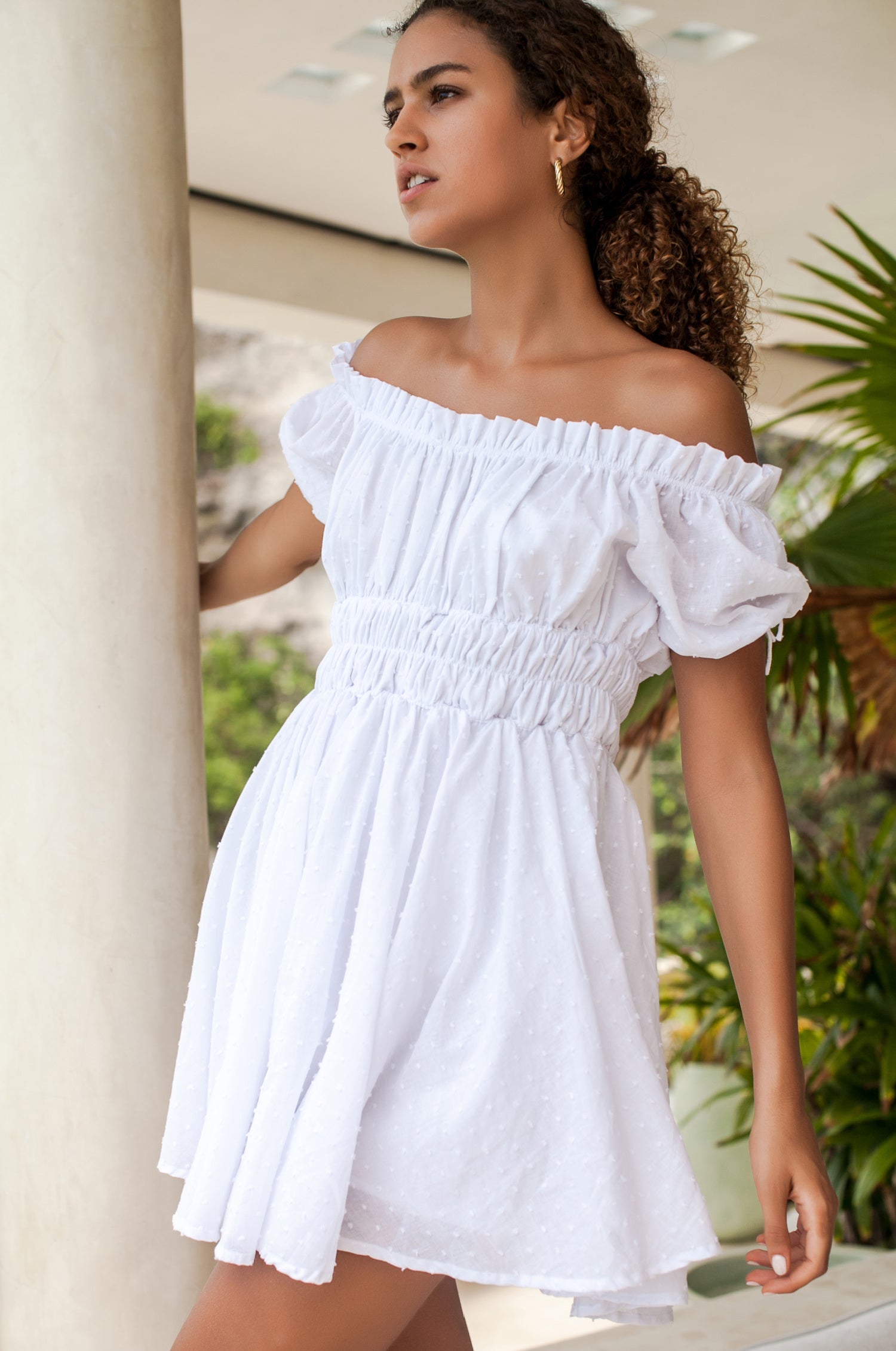 Butterfly Bliss Off Shoulder Mini Dress featuring puffed sleeves and a ruffled neckline, made from airy organic cotton in various colors.