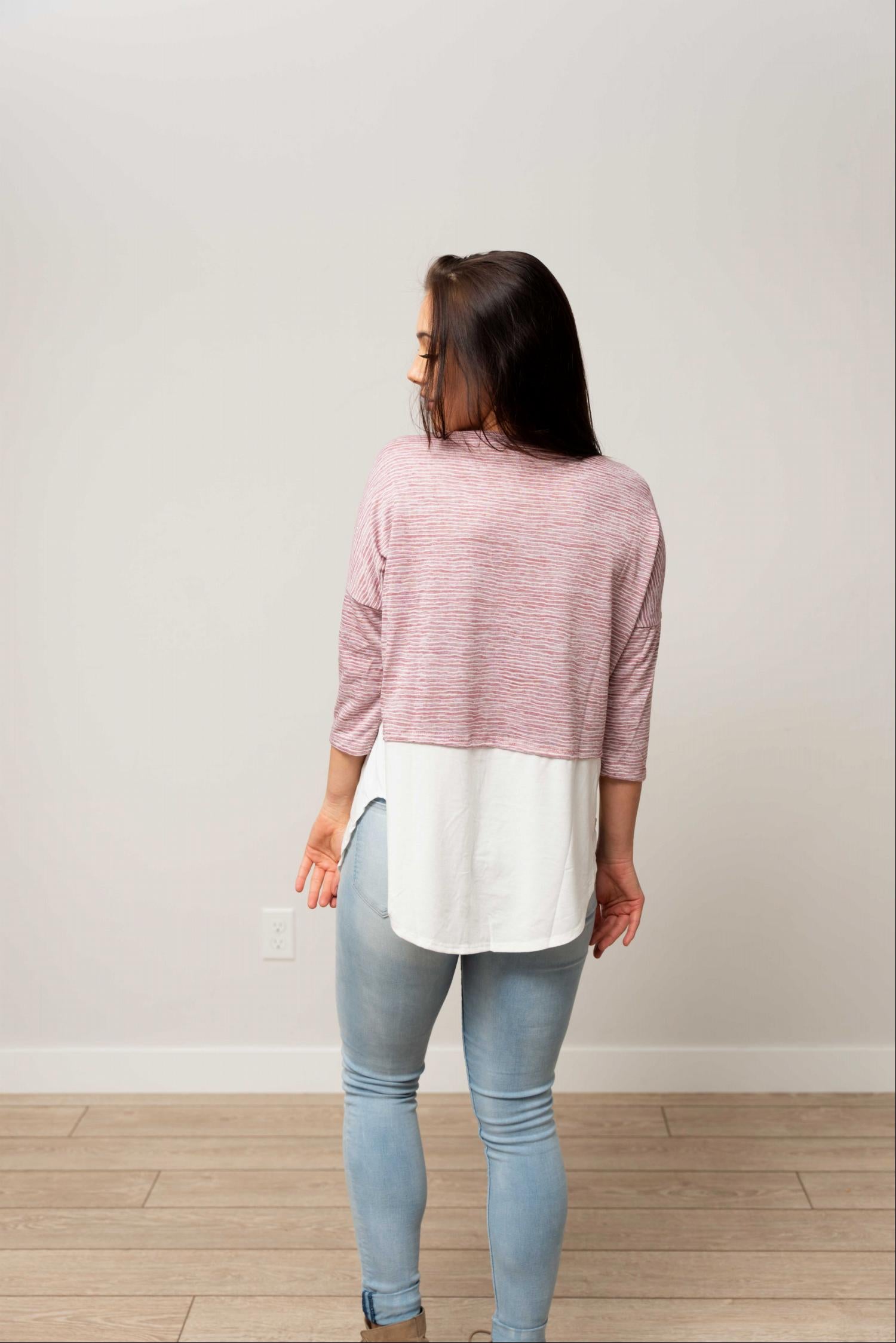 Button Down 3/4 Sleeve Knit Top featuring faux layered design, buttons, and rounded hemline in soft fabric.