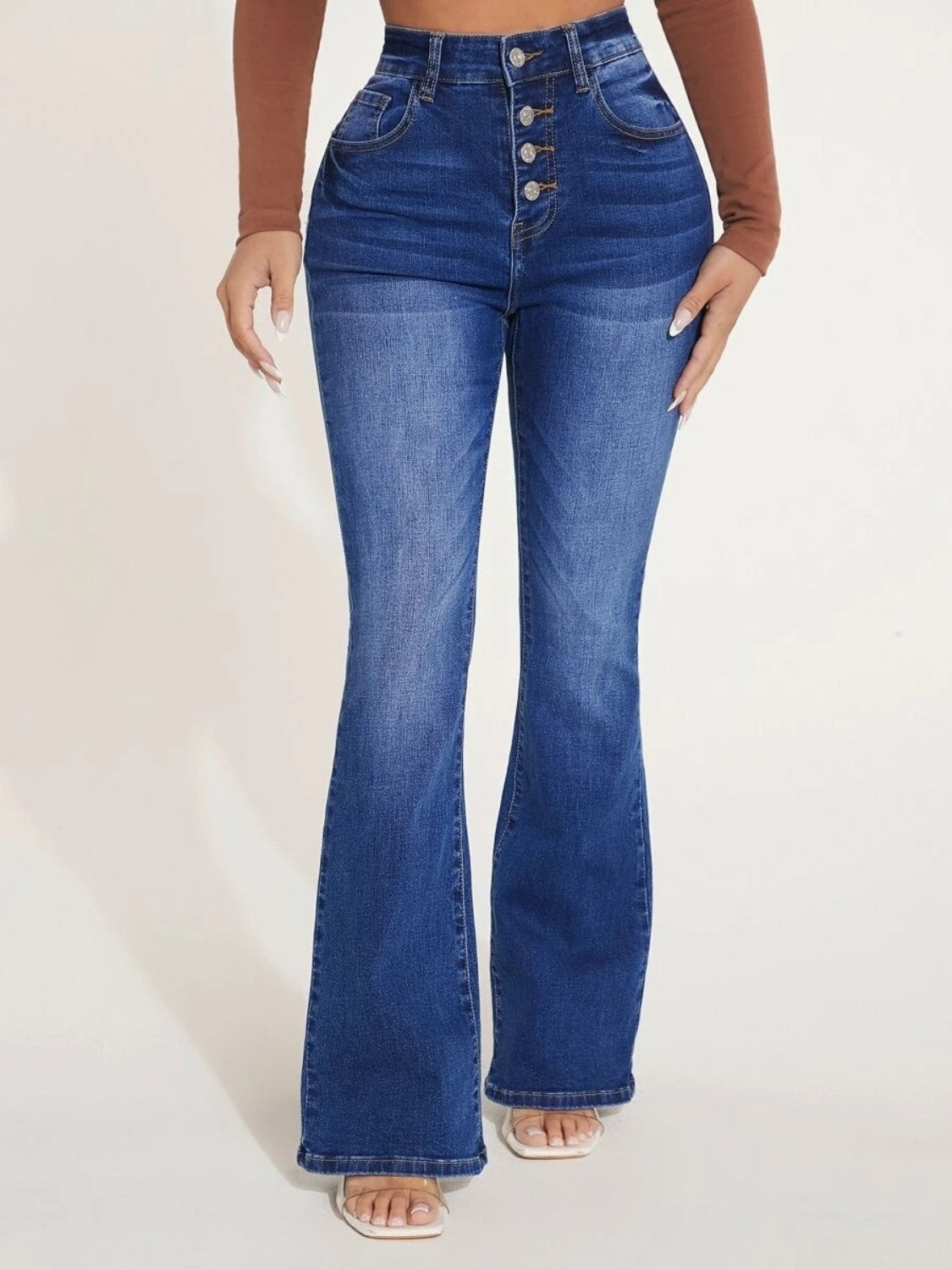 A pair of stylish button fly bootcut jeans with pockets, showcasing a moderate stretch fabric and a classic design suitable for various occasions.