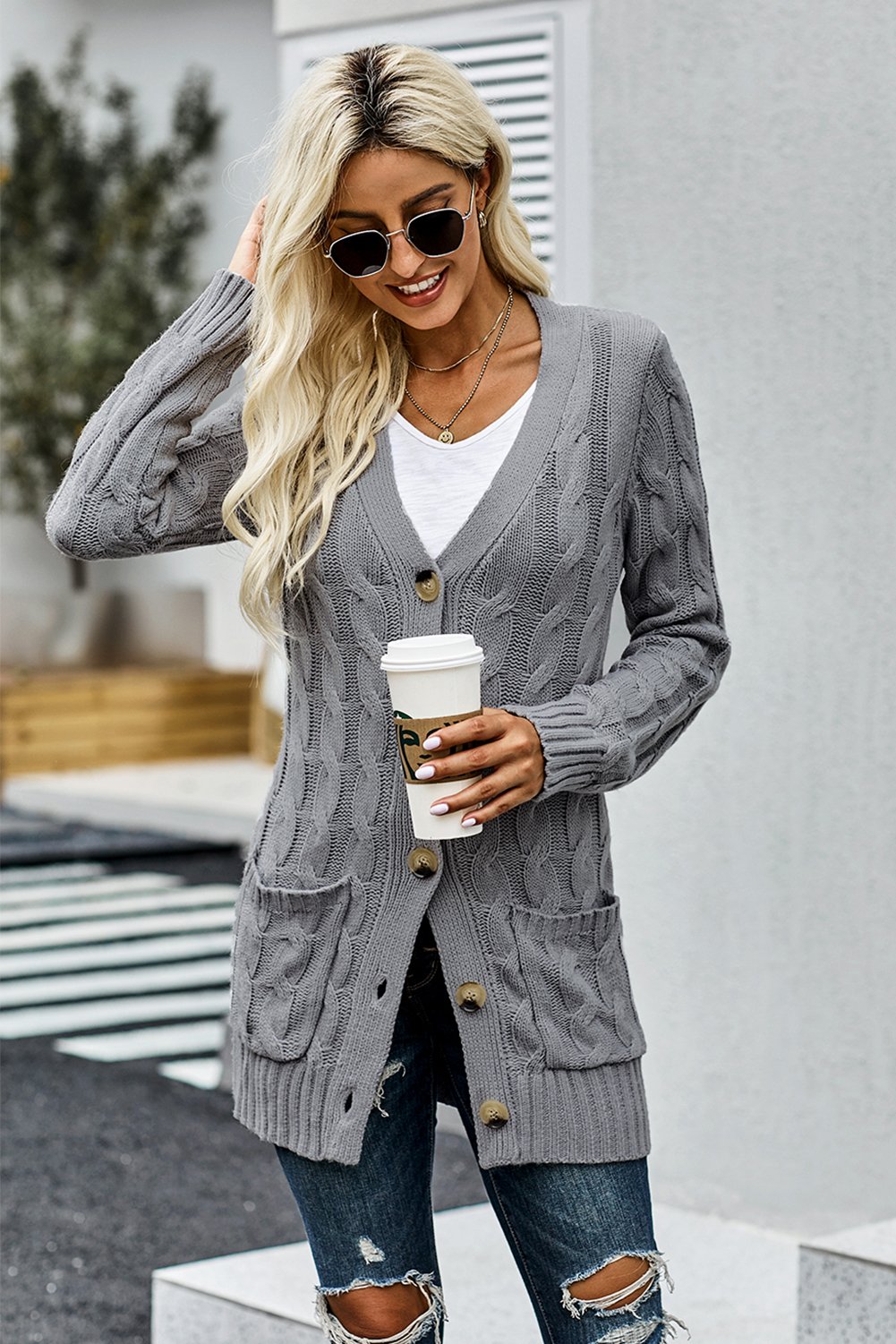 A cozy Button Pocket Knit Cardigan featuring a chunky button-up design, long sleeves, ribbed hem, and a front pocket, perfect for chilly days.