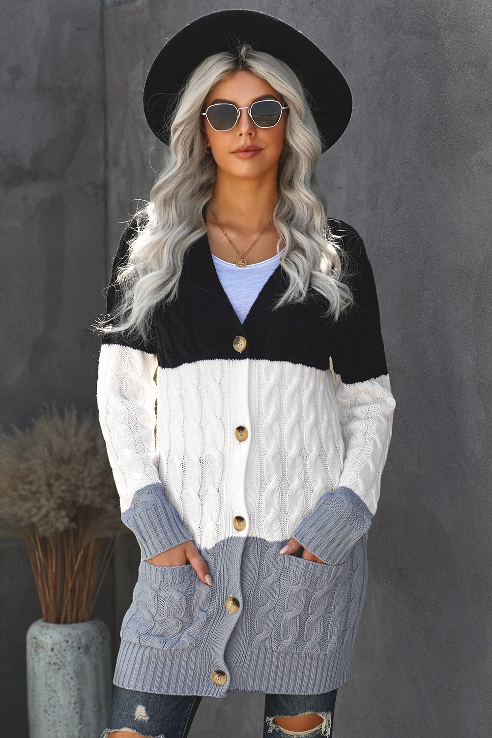 A cozy Button Pocket Knit Cardigan featuring a chunky button-up design, long sleeves, ribbed hem, and a front pocket, perfect for chilly days.