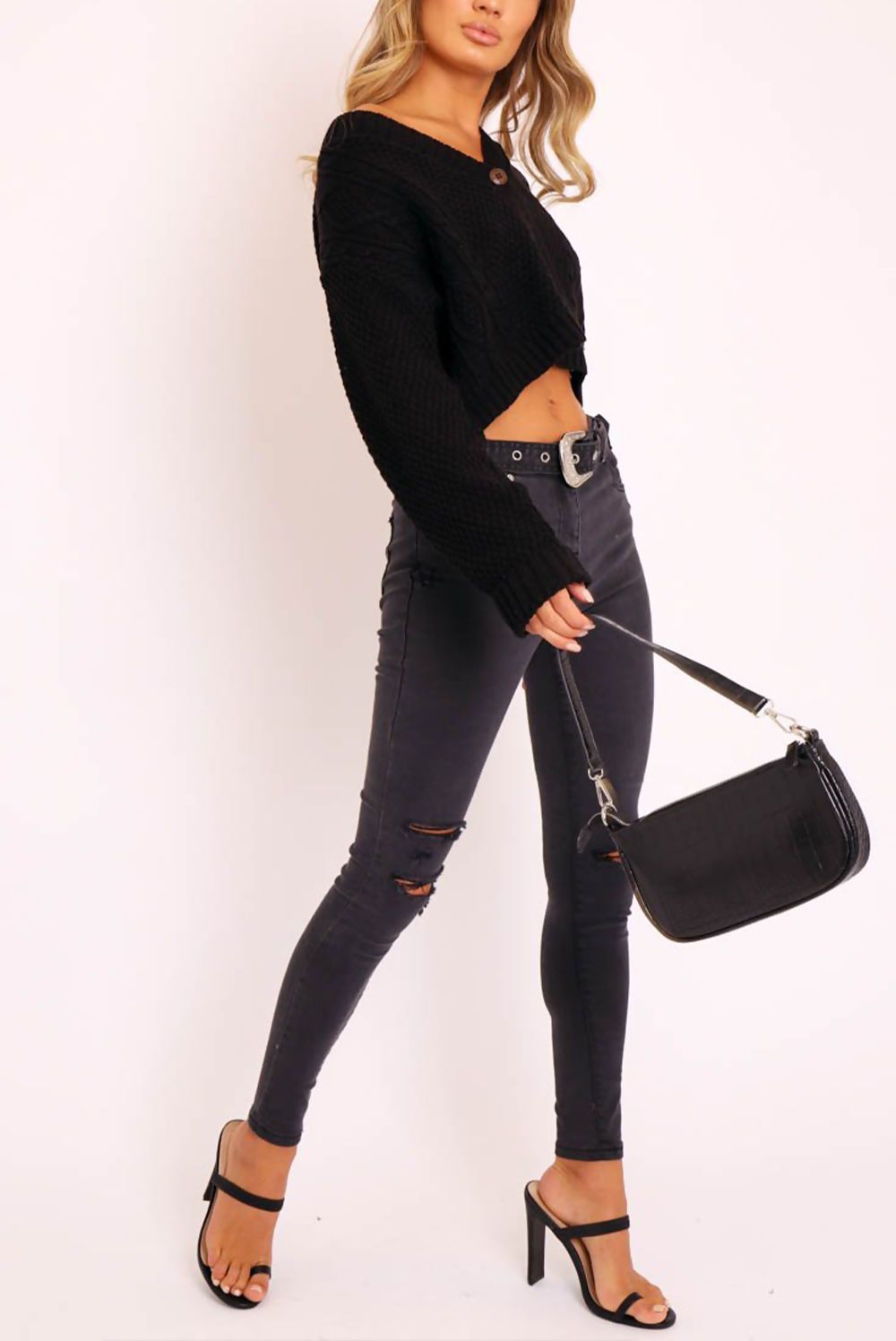 A stylish black cable knit cropped cardigan with button-up front, perfect for layering.