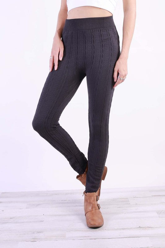 A pair of stylish Cable Knit Plus Leggings in various colors, featuring a soft fleece lining and a textured cable knit design.