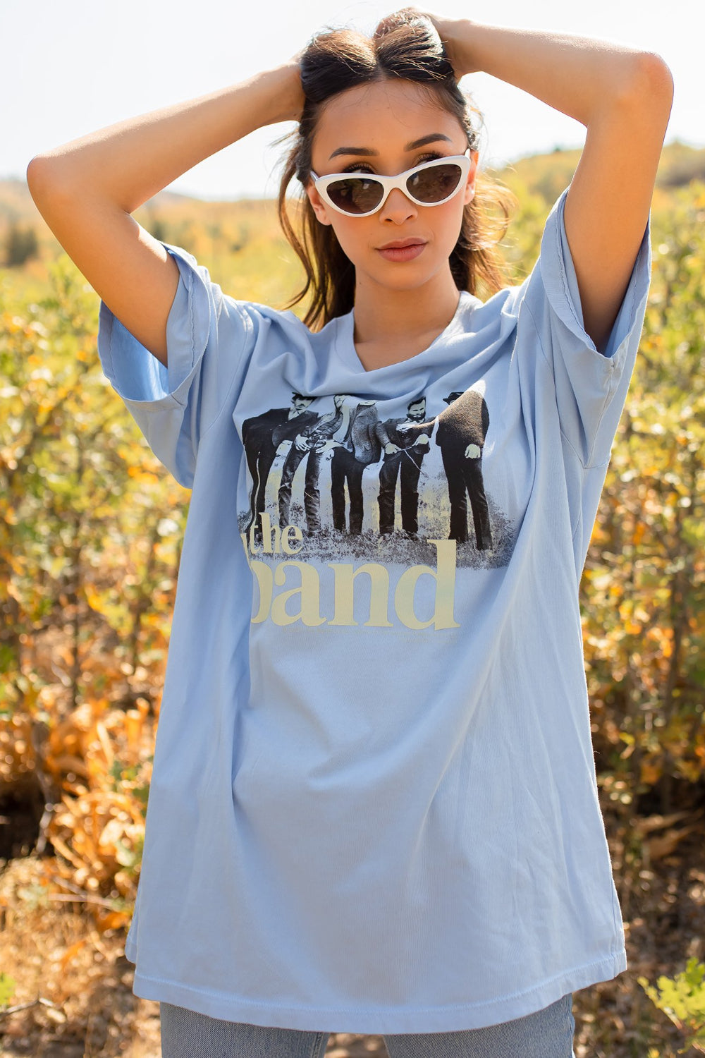 A blue oversized tee featuring a Cake graphic, made from 100% organic cotton, showcasing a relaxed fit and crewneck design.