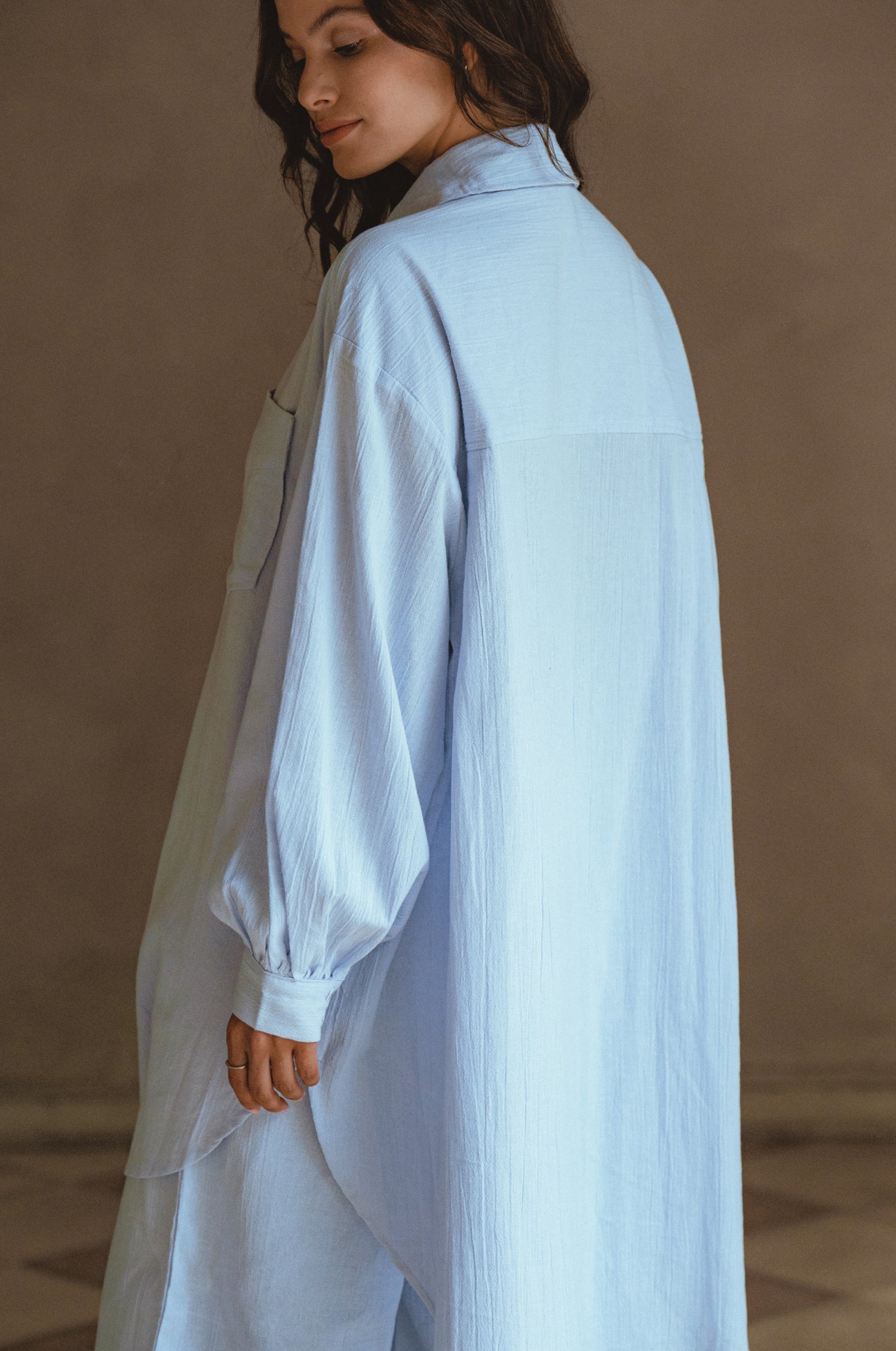 Calin Long Sleeve Oversized Shirt made from breathable linen, featuring a button-down style and high-low hem, displayed on a mannequin.