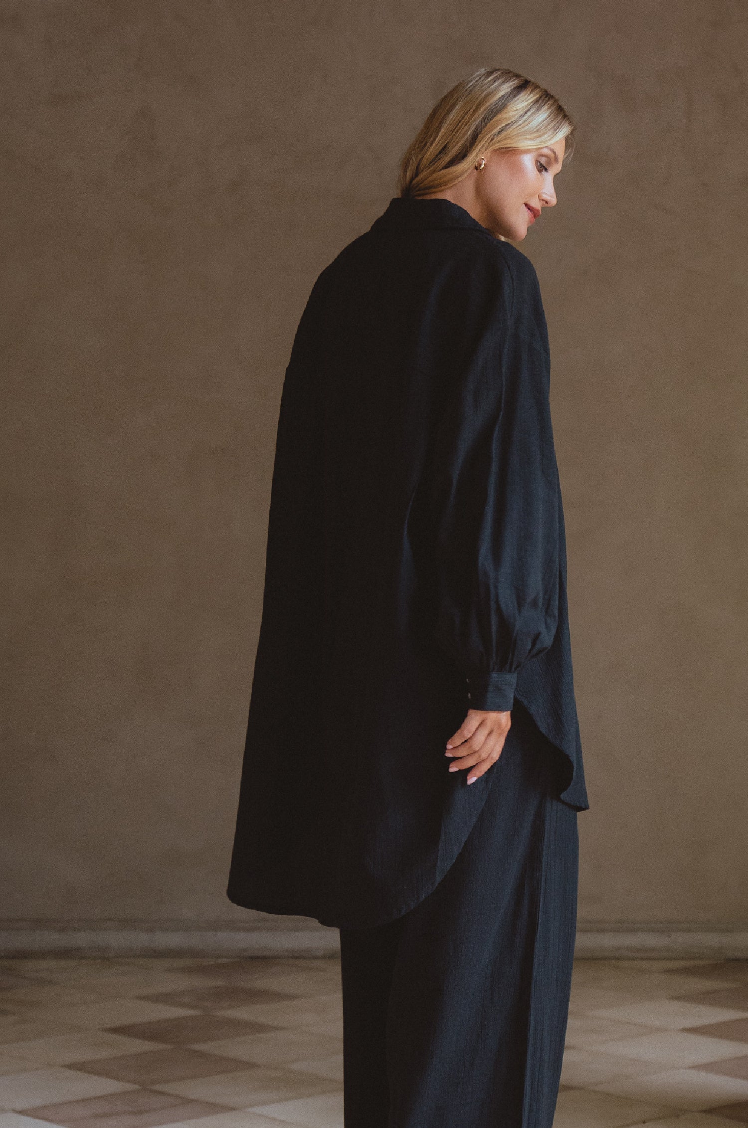 Calin Long Sleeve Oversized Shirt made from breathable linen, featuring a button-down style and high-low hem, displayed on a mannequin.