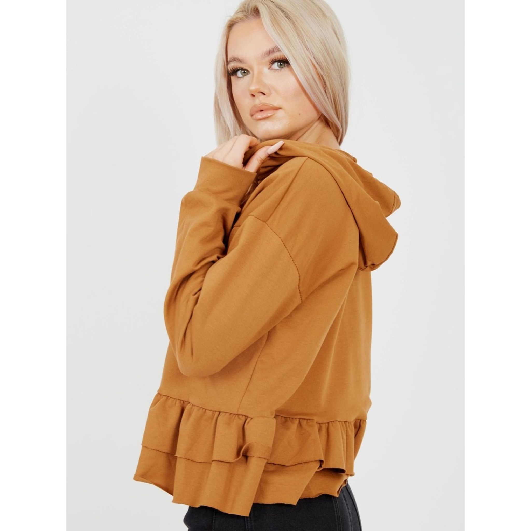 A stylish camel-colored hoodie with a layered frill hem and functional drawstring, perfect for casual wear.