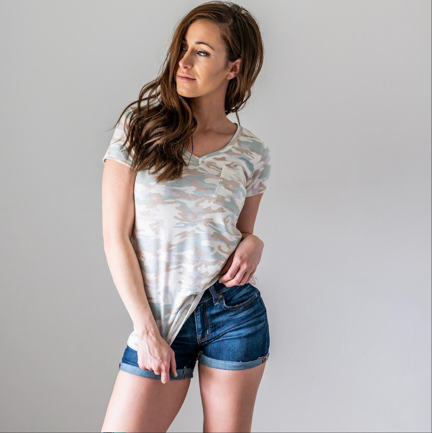 A stylish Camo V-Neck Top featuring a light camo print, short sleeves, and a front pocket, perfect for casual wear or as a beach cover-up.