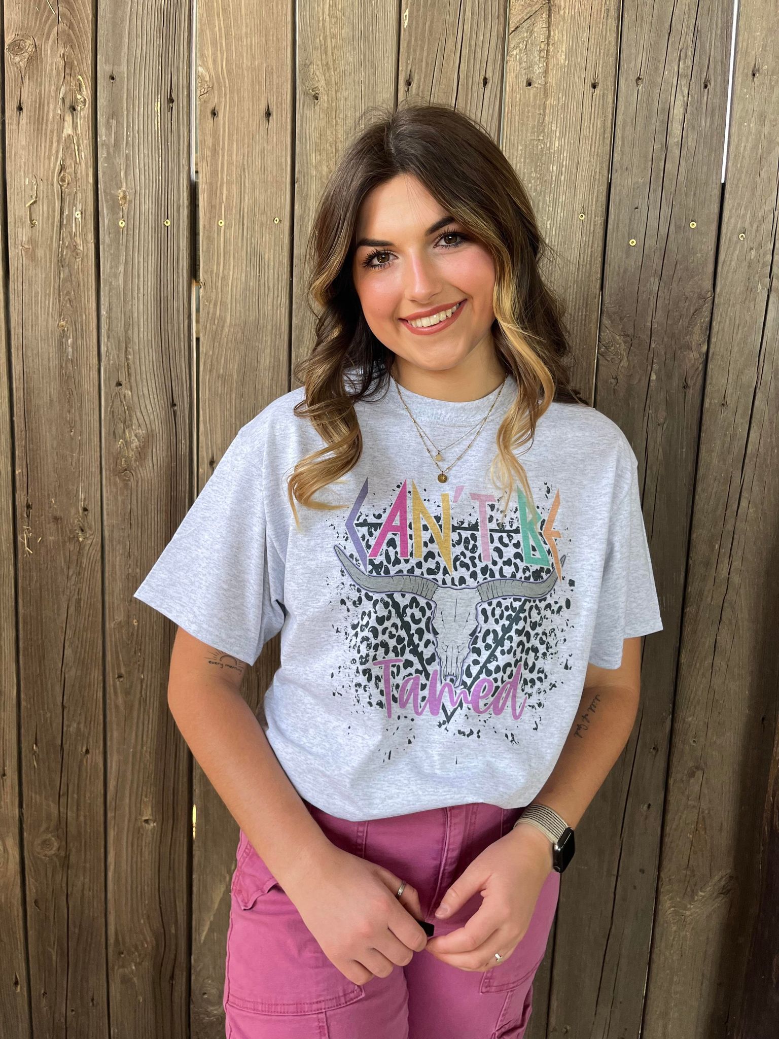 A vibrant Can't Be Tamed Tee featuring bold colors and unique design details, perfect for wild women.