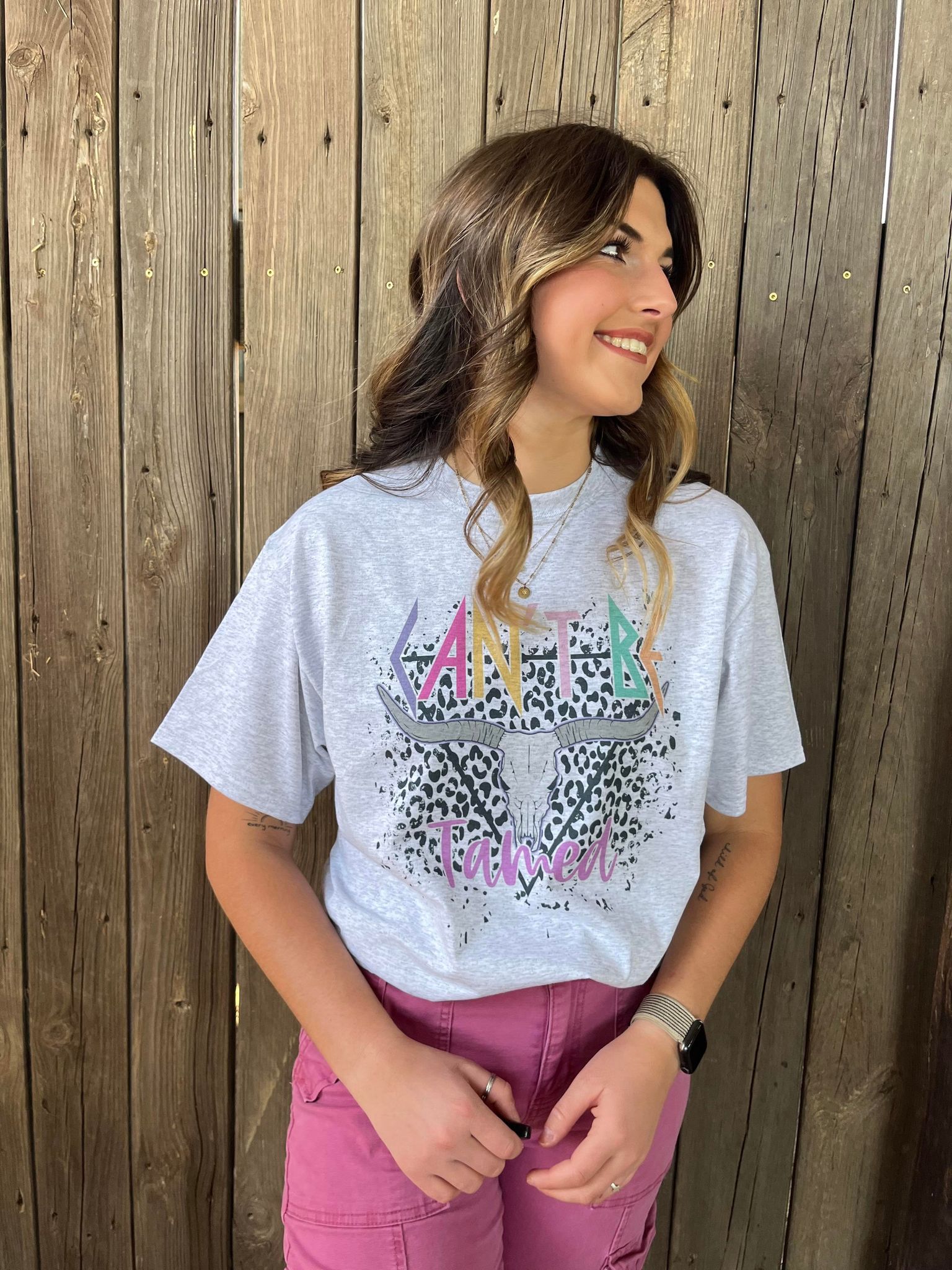 A vibrant Can't Be Tamed Tee featuring bold colors and unique design details, perfect for wild women.