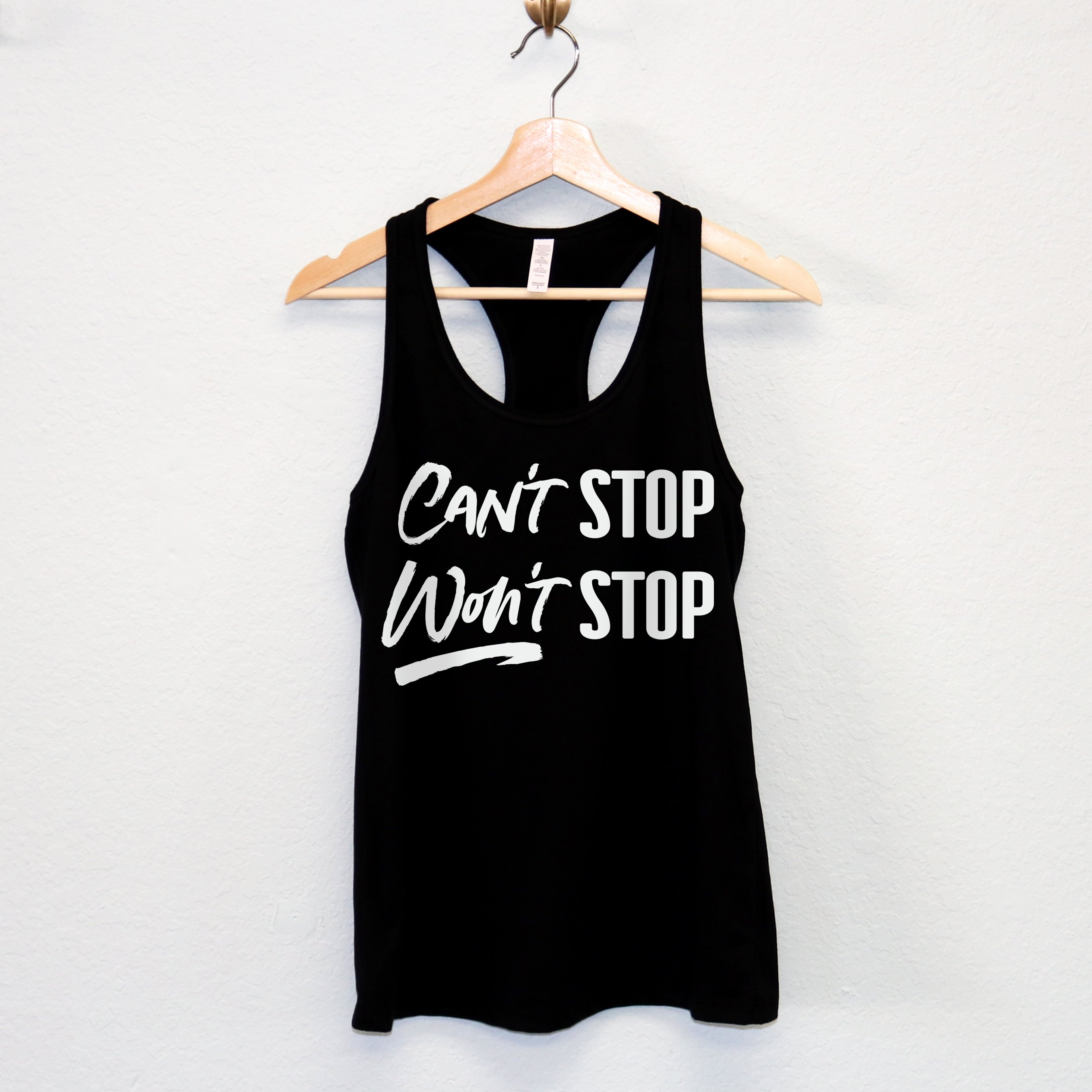 A stylish women's workout tank top featuring the motivational phrase 'CAN'T STOP WON'T STOP' in a racerback design, available in multiple colors.