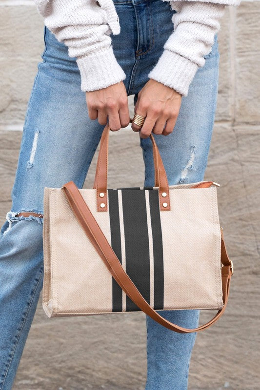 Stylish Canvas Stripe Tote with gold grommet detail and removable crossbody strap, showcasing its spacious design and multiple pockets.