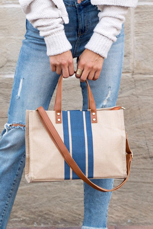 Stylish Canvas Stripe Tote with gold grommet detail and removable crossbody strap, showcasing its spacious design and multiple pockets.