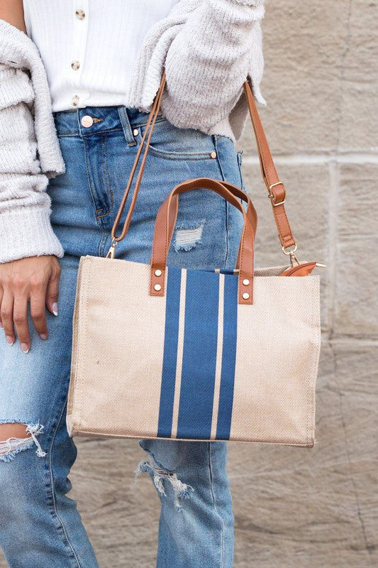 Stylish Canvas Stripe Tote with gold grommet detail and removable crossbody strap, showcasing its spacious design and multiple pockets.