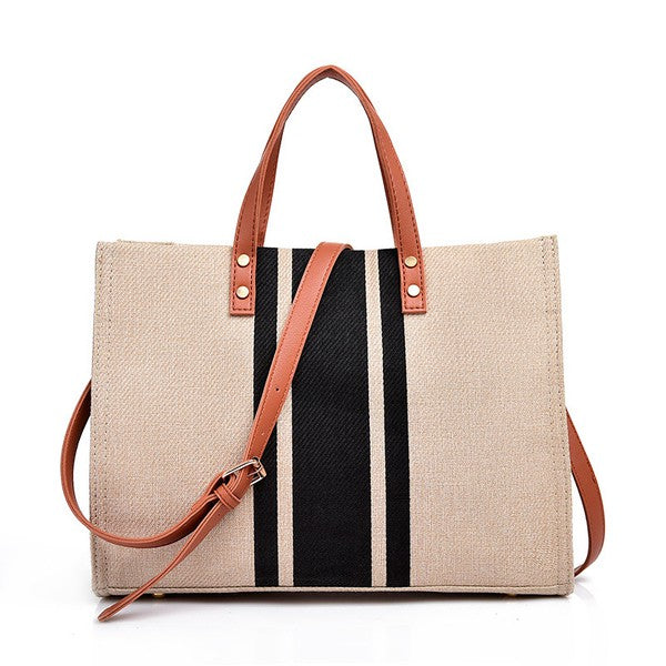 Stylish Canvas Stripe Tote with gold grommet detail and removable crossbody strap, showcasing its spacious design and multiple pockets.