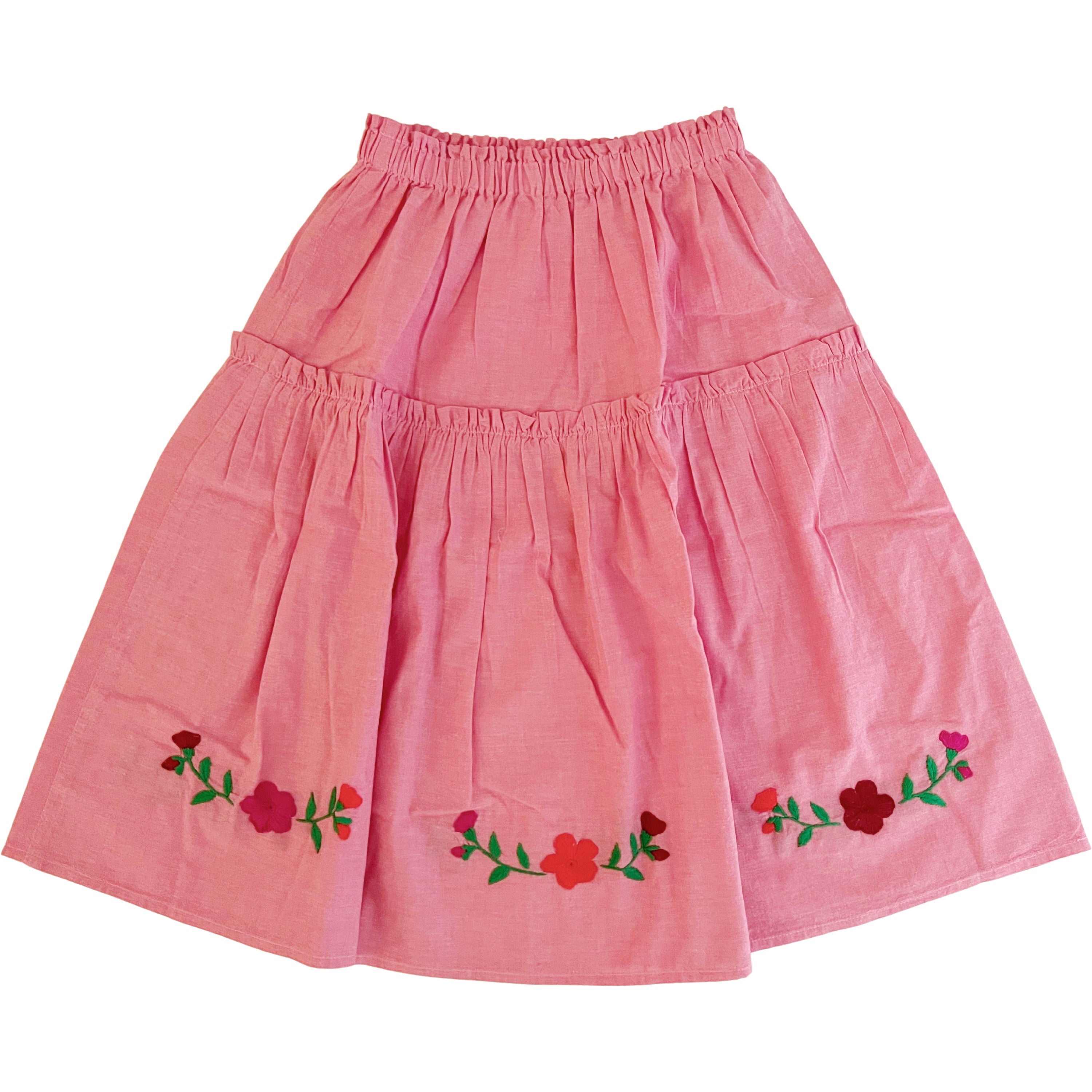 The Cari Skirt featuring intricate hand embroidery on pink chambray fabric, showcasing traditional artisan craftsmanship from Oaxaca, Mexico.