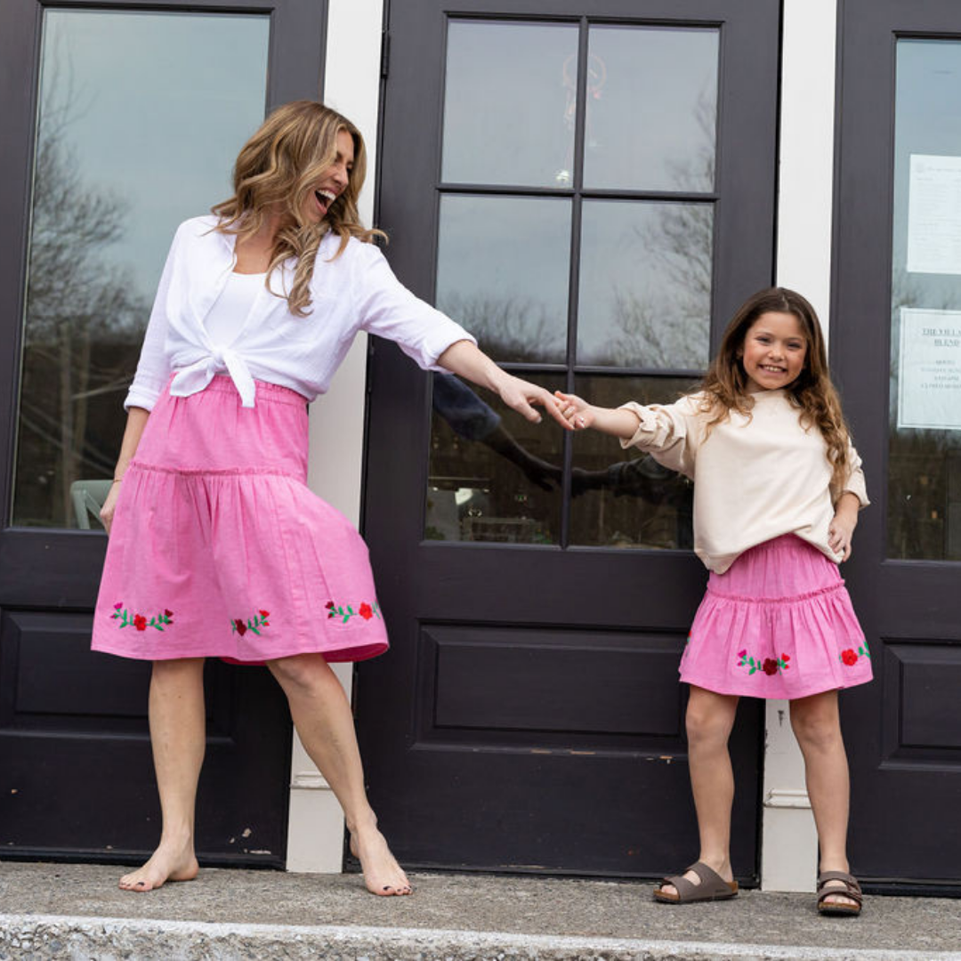 The Cari Skirt featuring intricate hand embroidery on pink chambray fabric, showcasing traditional artisan craftsmanship from Oaxaca, Mexico.