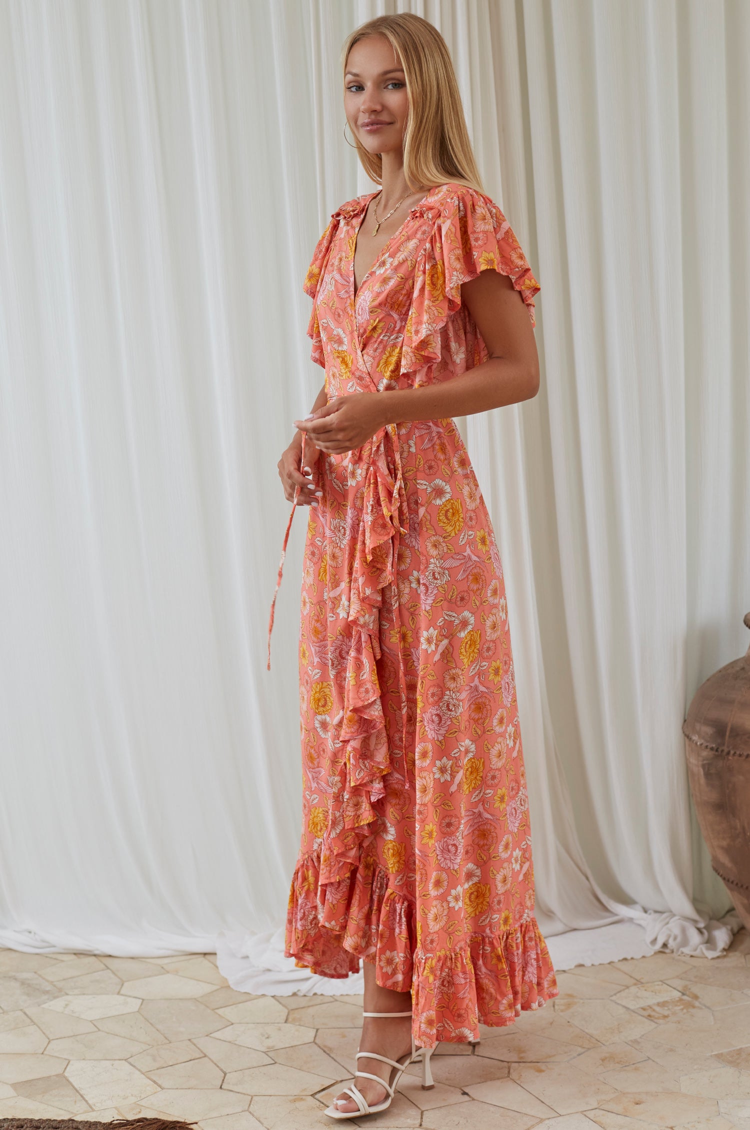 Carmen Wrap Maxi Dress featuring a soft rayon fabric, frilled hem, and a self-fabric tie at the waist, perfect for stylish occasions.